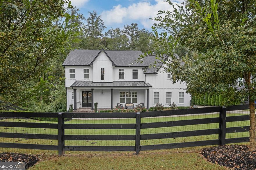 Welcome to this like-new modern farmhouse, perfectly situated on a quiet cul-de-sac in the coveted Tritt/Hightower/Pope school district. Set on a half-acre lot, this 5-bedroom, 4.5-bath home blends timeless style with today's most sought-after finishes. Step inside to an open, light-filled floor plan featuring hardwood floors and designer fixtures throughout. The show-stopping kitchen is the heart of the home with an expansive island, quartz countertops, marble backsplash, high-end appliances, and seamless views into the family room and dining areas. A spacious mudroom keeps life organized, and leads to the side facing 3-car garage, A newly built screened-in porch - complete with space for dining and lounging around the outdoor fireplace - makes everyday living feel like a retreat. The primary suite is a true sanctuary with a spa-like bath offering dual vanities, a free-standing tub, glass-enclosed shower and a DREAM closet that holds as many clothes and shoes as your heart desires! The finished basement expands your living options with a large family room, game/bar area, workout room or bedroom, and full bath. Outdoors, the newly landscaped backyard is fully fenced and features turf, a firepit area, and plenty of space for play. Located in a friendly neighborhood with an optional HOA offering pool and tennis amenities, this home delivers the perfect blend of comfort, community, and convenience.