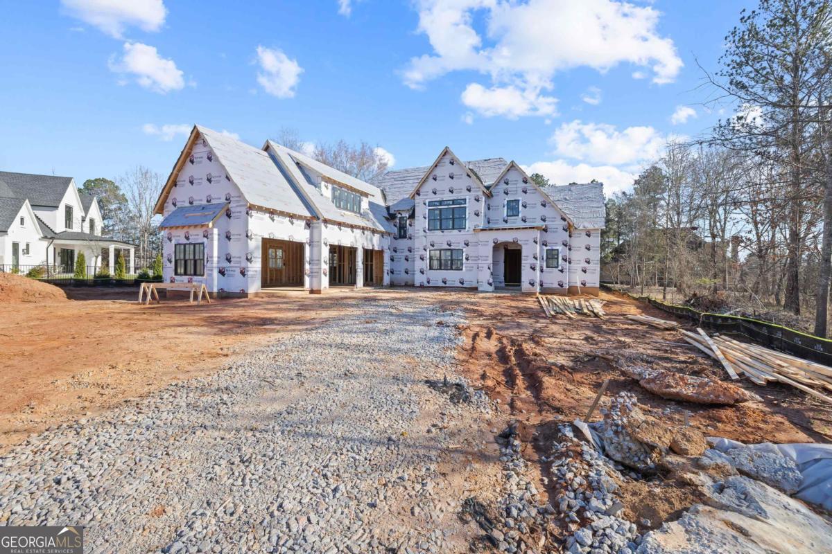Welcome to 207 Eagles Way, an exquisite new construction home in the prestigious Cuscowilla at Lake Oconee. Nestled within this private, gated golf and lakefront community, this stunning 5-bedroom, 4-bath, 3 half-bath residence offers the perfect blend of luxury, comfort, and timeless design. Designed for lakefront living at its finest, this home includes a dedicated dock slip with 24/7 access, making it easy to enjoy endless boating, fishing, and water activities on the crystal-clear waters of Lake Oconee. 5 Bedrooms 4 Full Baths 3 Half Baths - Spacious, thoughtfully designed layout perfect for entertaining and everyday living. Gourmet Kitchen - High-end appliances, custom cabinetry, and an oversized island. Open-Concept Living Areas - Elegant finishes, soaring ceilings, and expansive windows that bring in natural light. Primary Suite Retreat - Spa-like ensuite bath and large walk-in closet. Outdoor Living - Covered porches and entertaining spaces to take in the serene lake views. Dedicated Dock Slip - Private and convenient lake access for year-round enjoyment. Located in Cuscowilla, a renowned Coore & Crenshaw-designed golf course community, residents enjoy access to world-class golf, a clubhouse, resort-style pools, tennis courts, fine dining, and more. This under-construction home is an incredible opportunity to customize your dream home on Lake Oconee. Contact us today for more details on finishes, timeline, and how to make this lakefront masterpiece yours!