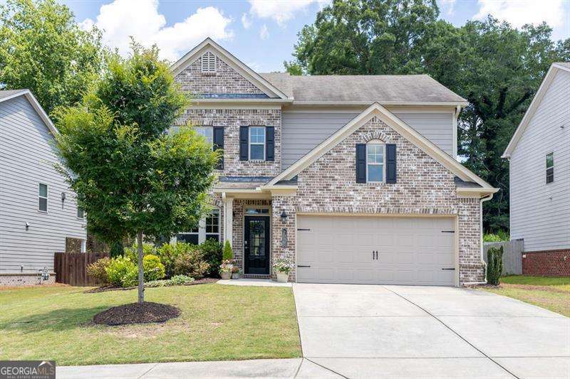 Now's your opportunity to live in a great location. Welcome home to this beautifully appointed 4 bedroom, 2.5 bath house in Lakeview at Ivy Creek. Entering the home you will step into a large foyer with lovely wainscoting, 9' ceilings, and hardwoods throughout first floor. Off the foyer is a flexible room that could be a dining, living, office, or play room. The half bath is a charmer with gold hardware, tall paneling, and tasteful wallpaper. Enjoy open concept living with kitchen, dining area, and family room with fireplace to rear of home. The kitchen has 42" upper cabinets, granite countertops, SS appliances including range, microwave, and dishwasher. There's even a space for a coffee station. Enjoy privacy outside under a covered porch. The large fenced, flat backyard has been professionally landscaped and includes a firepit area. Upstairs a generous landing leads to the primary suite with spa-like bathroom and large walk in closet. Three additional bedrooms along with extra bath with double vanity offer plenty of room for growth. Upstairs is a generous sized laundry room. The Community Pool and mail kiosk are directly across the street. Take a stroll through the neighborhood enjoying wooded areas and even a small pond. So close to Mall of Georgia, Little Mulberry Park, The Exchange, Interstates, and so many other great attractions. You will want to make this house your home!