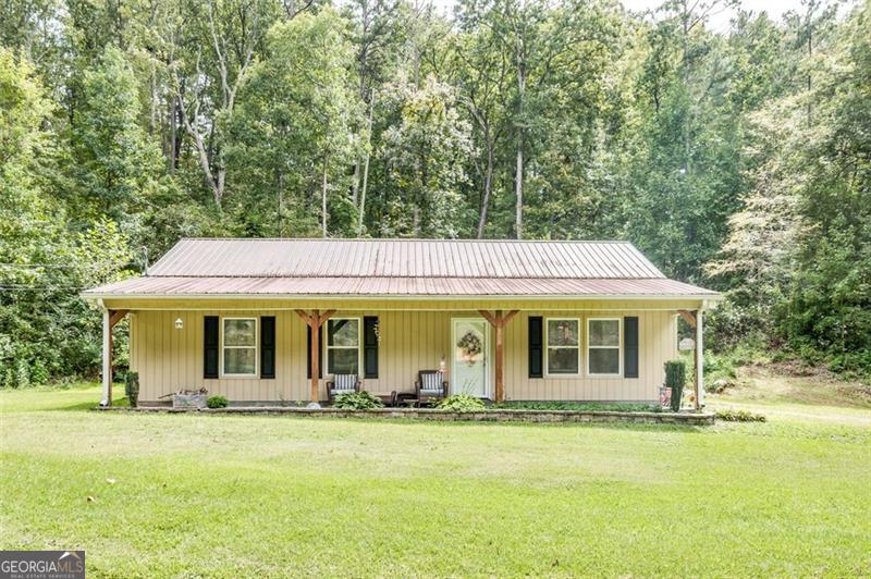 Discover the perfect blend of charm and comfort in this beautifully maintained ranch-style home. A durable metal roof and inviting covered front porch set the tone for timeless appeal. Inside, the spacious open floor plan is filled with natural light, creating a warm and welcoming atmosphere ideal for both everyday living and entertaining. The dining area showcases elegant board-and-batten detailing, while the kitchen features sleek stainless steel appliances and a functional layout for the modern homeowner. With 3 bedrooms and 2 full baths, this home offers both style and practicality. Step outside to enjoy a large yard framed by a mature privacy tree line-perfect for gatherings, gardening, or quiet relaxation. Located just 10 minutes from Downtown Rome, this home combines everyday convenience with a peaceful setting. This property offers thoughtful design, great incentives, and an unbeatable location-making it a wonderful place to call home. Ask about our Lender-Paid 1-0 Buydown, lowering your interest rate by 1%