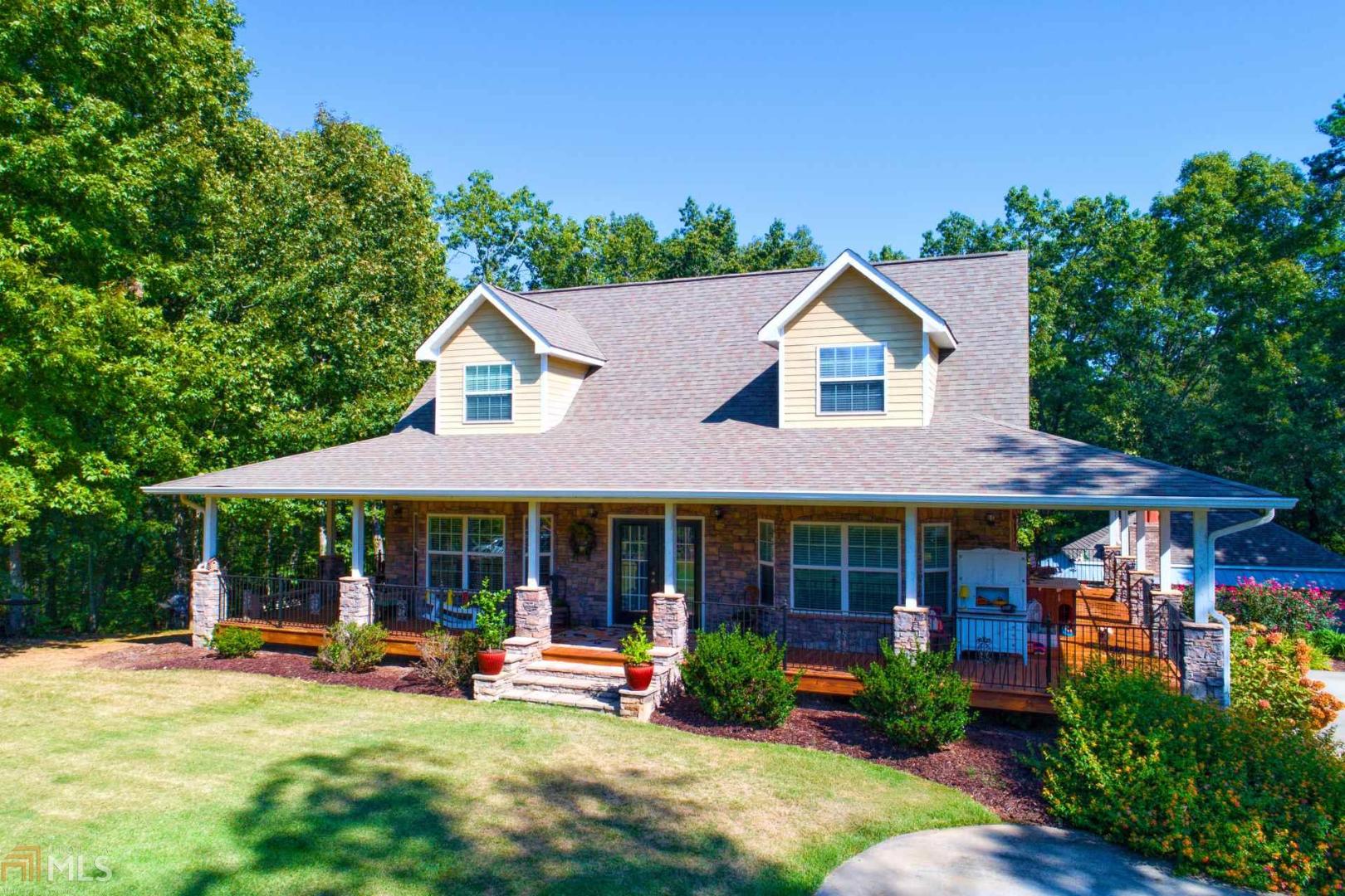 Beautiful home with a 1200 sq ft wrap around porch. Wonderful screened porch overlooking pool and private wooded back view. Lots of entertaining space here for outdoor cooking and watching TV on the outdoor television. 2 outdoor kitchens and an outdoor fireplace and a fire pit. Main level has an open concept design with hardwood floors. Master bathroom has an awesome shower with multiple body jets and sprays. 80 gallon hot water heater. Total electric with a owner owned propane tank for gas logs in the 2 indoor fireplaces. Located on quiet, dead end street. Over 4100 square feet of indoor living space along with lots of outdoor living space.