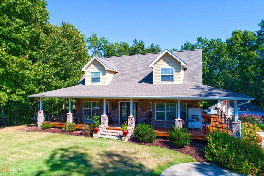 Beautiful home with a 1200 sq ft wrap around porch.  Wonderful screened porch overlooking pool and private wooded back view.  Lots of entertaining space here for outdoor cooking and watching TV on the outdoor television. 2 outdoor kitchens and an outdoor fireplace and a fire pit.   Main level has an open concept design with hardwood floors.  Master bathroom has an awesome shower with multiple body jets and sprays. 80 gallon hot water heater.  Total electric with a owner owned propane tank for gas logs in the 2 indoor fireplaces.   Located on quiet, dead end street. Over 4100 square feet of indoor living space along with lots of outdoor living space.
