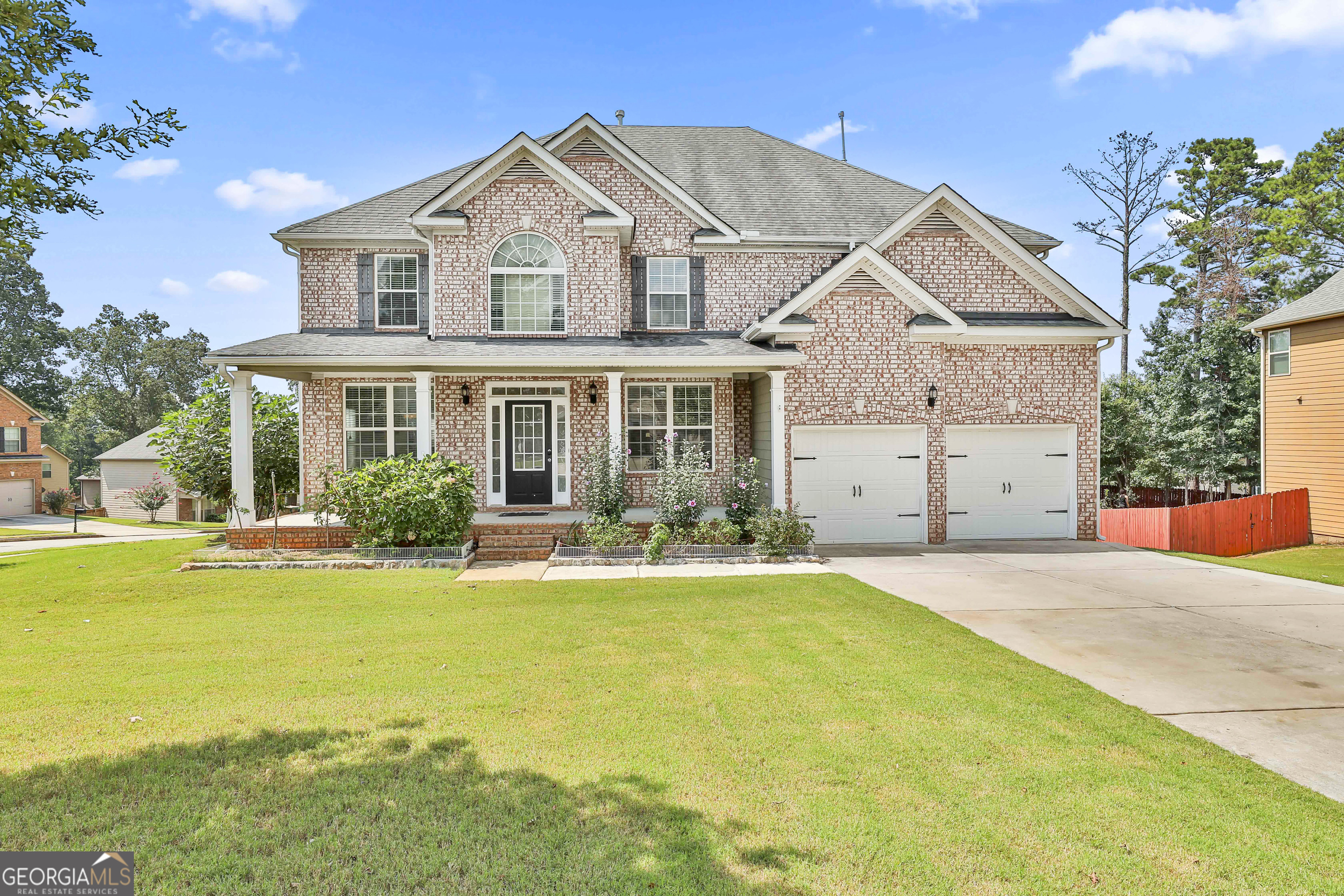 Located within the Residential Newnan Area, Welcome to this Beautiful 2 Story 5-Bedroom 4.5-Bathroom Home in The Highlands at Newnan Crossing, Complete with a Fully Finished Basement, an Open Deck connected to the Living Room, and a shaded Patio Beneath the Deck Accessible from the Basement Living Room. Starting from the Front, the Home features a Driveway with Sufficient Parking Space Leading up to a Double Garage, as well as an Elevated Front Porch Entrance on the Left. When Entering the Home, You will find 2 Dining and Gathering Areas Located to the Left and Right, With the Left being Connected to a Kitchen, Featuring an Island for Additional Seating or Space for Food Preparation. Beyond the Kitchen features a Breakfast Nook with 2 Double Windows for the Refreshing View on top of the Hill. Connected to the Kitchen is an Adjoined Living Room area, Featuring a Ceiling Fan for the Hot Summer Months and a Fireplace for the Warm Cozy Winters, as well as a Door leading to the Outside Deck for a Completely Open and Refreshing area. With the Seamless Transitions between Dining/Gathering areas, Kitchen, Breakfast Nook, Living Room, and the Outside Deck, the Main Floor is Perfect for Hosting Gatherings and Convening with Groups of People, and is also Flexible Enough for the Areas to be used for Other Purposes, such as Office Spaces or Additional Relaxing Lounges. The Main Floor primarily features Luxury Vinyl Plank flooring, including the Bedroom and Full Bathroom quietly tucked away towards the back of the Living Room Area. The Second Floor features 4 All-Carpeted Bedrooms and 3 Bathrooms, with a Spacious Primary Bedroom containing a Primary Bathroom with a Beautiful Glass Shower and Walk-In Closet, a Secondary Spacious Room containing a Private Bathroom, and two Standard Bedrooms with a Shared Bathroom. The Upstairs Hallway also contains 2 Linen Closets for Additional Storage. Heading Down, the Basement is Fully Finished, and contains a main Basement Living Room, and 4 Individual Areas that can be Tailored to Your Liking, Whether it be Additional Gathering and Entertainment Areas, or Spaces Designated for Hobbies. The Basement also Features a Convenient Half-Bathroom, and the Basement Living Room is directly connected to the Backyard Patio, which is located underneath the Deck, providing Shade and Coziness depending on the Season. Lastly, the Home is Conveniently Located within 2 Miles from Walmart, Kroger, and Publix for Close Shopping Trips, within 3 Miles of the Piedmont Newnan Hospital, and is 3 Miles away from Ashley Park, an Outlet Mall filled with Restaurants and Shops. The Highlands at Newnan Crossing is tucked into a Residential Area, but is also within Close Proximity to various Restaurants, Hardware Stores, Clothing Stores, and so much more. The Home is also Located Close to the I-85 Highway for Long Distance needs. Given all of the Qualities and Conveniences this Home Provides, Please Schedule an Appointment to see Everything that this Home has to Offer.