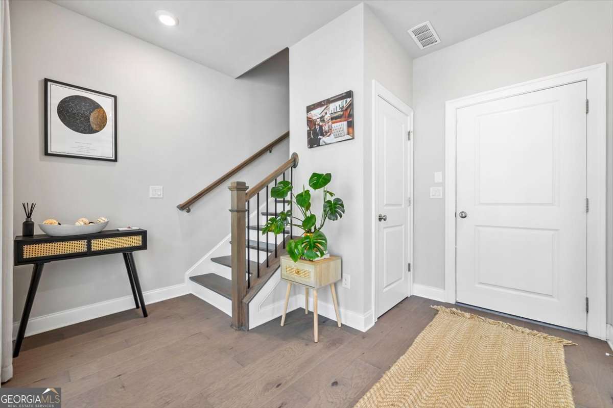 Beautiful End Unit Townhome in the Heart of Alpharetta! One month rent-free with signed lease by 9/15/2025. Located just steps from The Maxwell Retail and vibrant downtown Alpharetta, this stunning end-unit townhome offers the perfect blend of luxury and convenience. Inside, you'll find an open-concept layout with hardwood floors throughout, high ceilings (9-10 ft), and floor-to-ceiling windows that fill the space with natural light. The gourmet kitchen is a showstopper, featuring stainless steel appliances, quartz countertops, an oversized island, a custom tile backsplash, and soft-close cabinetry. The spacious deck off the main living area is ideal for grilling and entertaining. Enjoy stylish touches like upgraded lighting, custom paint, crown molding, and a cozy fireplace with a white brick surround and shiplap accent. The primary suite boasts two walk-in closets with custom organizers and a spa-like bathroom. Additional features include a private, fenced aluminum front yard, a 2-car garage with an electric car charging outlet, and all appliances included. Community amenities include a pool, clubhouse, bocce ball court, open green space, and direct access to The Alpha Loop. Walk to Alpharetta City Center, Avalon, and more. Quick access to GA-400, North Point, and top local attractions. Agent Owned. Call for pet policy.