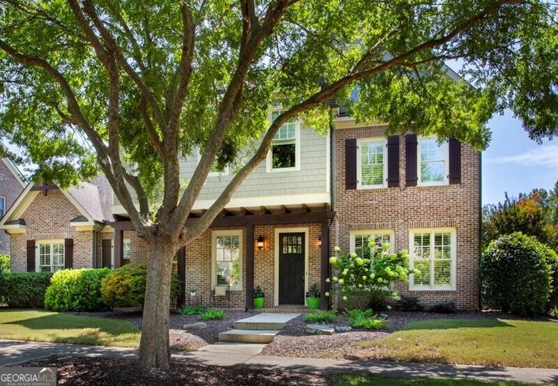 Welcome home to 1095 Lunsford Circle - a sun-drenched, entertainer's dream in one of Alpharetta's most desirable communities. Situated in front of a wide open green space with lawn maintenance included by the HOA, this home offers effortless "lock-and-leave" living with timeless style and modern comfort. Zoned to top-rated schools and just minutes to Avalon, Downtown Alpharetta, and the charming shops and restaurants of Crabapple - this one truly has it all. Step inside to soaring 10-foot ceilings, plantation shutters, custom trim, and windows galore. The open-concept main level is centered around a chef's kitchen with granite countertops, a large island, double ovens, stainless appliances, walk-in pantry, and a clear view to the fireside great room. French doors lead from the great room to a private backyard oasis featuring a patio with outdoor fireplace - perfect for fall evenings or weekend gatherings. The heart of this home is its exceptional indoor-outdoor flow. French doors from both the foyer and the kitchen also open to the covered back patio, giving you multiple ways to enjoy the fully fenced backyard space. With everything open, it's an ideal setting for entertaining or just enjoying the breeze. The main-level primary suite is filled with natural light and offers a spa-inspired bath and a custom walk-in closet. Upstairs, you'll find a spacious loft along with three additional bedrooms and two full bathrooms - offering flexibility for guests, work-from-home, or play space. Additional features include a mudroom with built-in drop zone, a separate laundry room, a fenced side yard, 3-car garage, and whole-home surround sound. With no yard work, an unbeatable location, and a layout designed for both daily ease and weekend fun. 1095 Lunsford Circle is the lifestyle upgrade you've been waiting for.