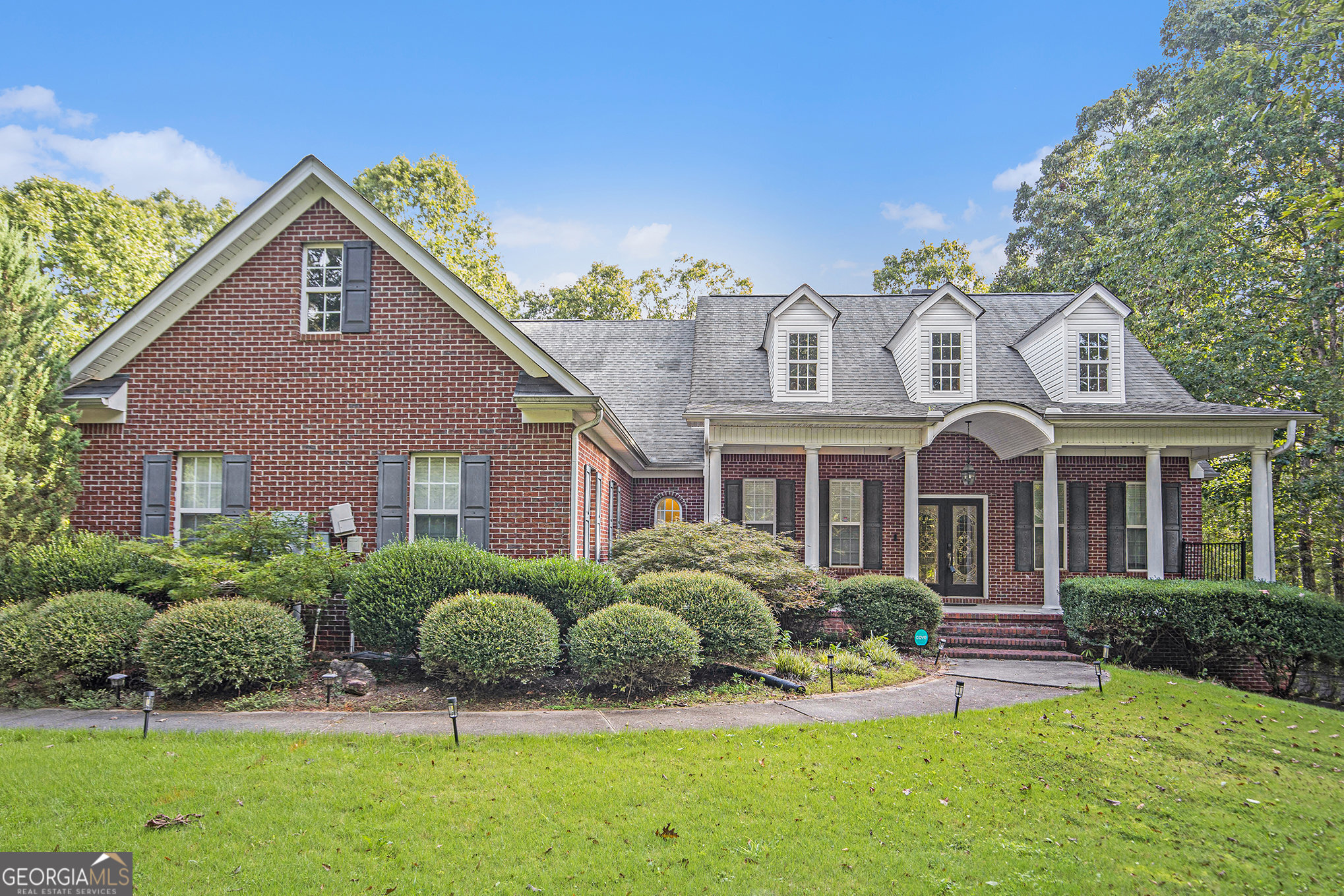 Stunning 4-Sided Brick Home on 4.22 Acres in Danielle Estates Welcome to this remarkable 4-sided brick home, perfectly situated on 4.22 fully fenced acres in the desirable Danielle Estates subdivision. Tucked away on a private wooded lot, this property offers both comfort and seclusion with a long driveway that wraps to the rear of the home, leading to an attached garage and spacious parking pad. The expansive backyard is perfect for entertaining, complete with a firepit and additional outdoor sitting area. Step up to the full-length covered front porch and through the double-door entryway, where you are greeted by a soaring vaulted foyer with beamed ceilings and hardwood floors throughout. The formal dining room, with space for up to 12 guests, is accented by wood beams for a warm and elegant touch. The large living room features built-in shelving and cabinetry framing a stacked stone fireplace, creating the perfect spot for gatherings. The open-concept kitchen offers stained cabinetry, double ovens, an electric cooktop, and a large island. An adjoining breakfast area overlooks an additional den, providing even more living space on the main level. The private owner's suite is located on its own wing of the home and boasts cathedral-beamed ceilings with wood accents, a spa-like renovated ensuite with double vanities, tile flooring, a soaking tub, a tiled shower, and a generous walk-in closet. Two additional bedrooms on the main level share a convenient Jack-and-Jill bathroom. Upstairs, you'll find a full in-law suite with a private living area, full bedroom and bathroom, walk-in closet, extra coat closet, and attic storage. The fully finished basement offers limitless possibilities-featuring a large living room, additional bedroom with closet, a gym or theater-ready flex room, dining area, multiple storage rooms, and a full workshop with a boat door. This one-of-a-kind property combines privacy, space, and functionality in a premier location. Don't wait-schedule your private tour today and experience all this home has to offer!