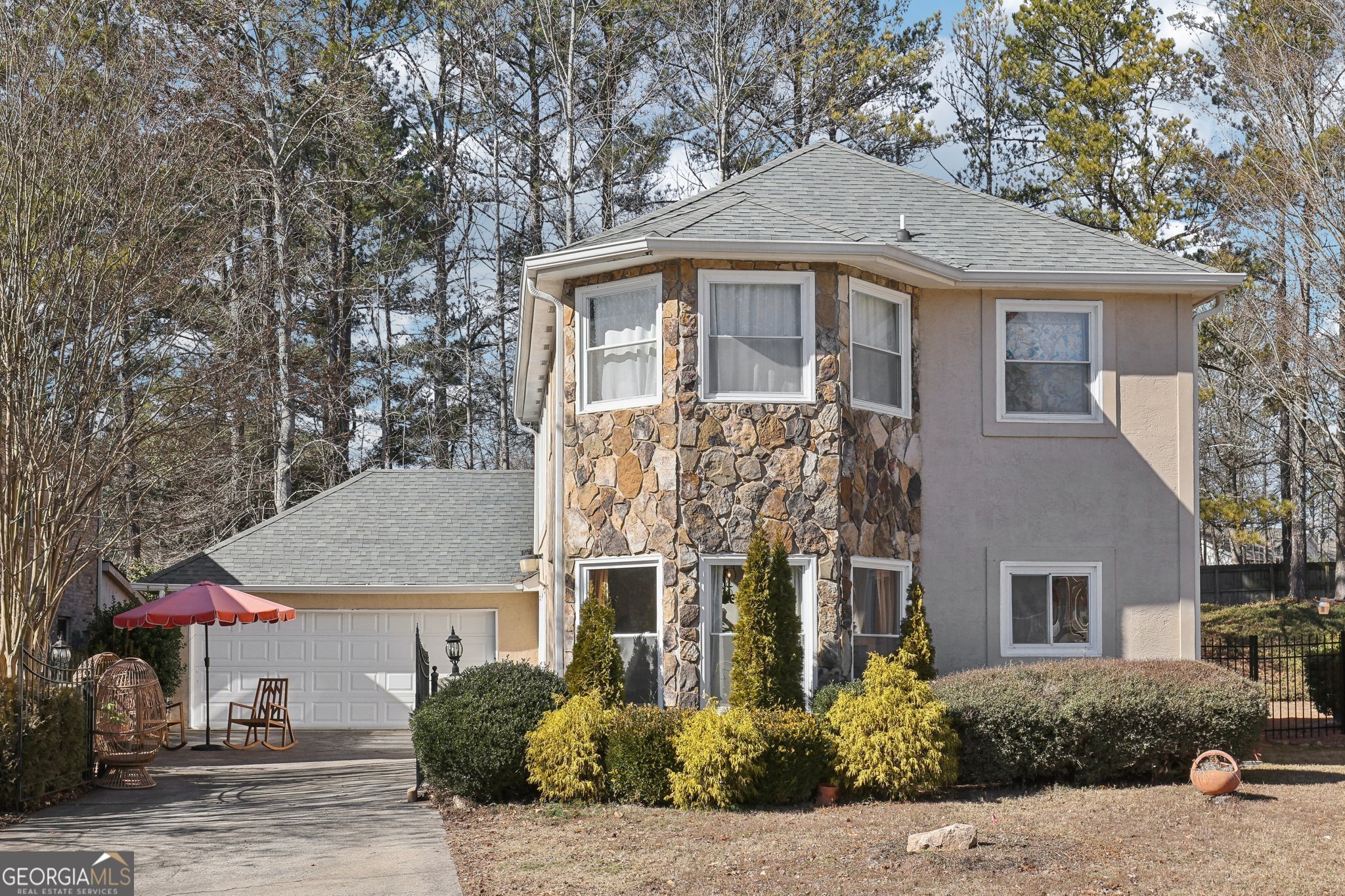 East-facing with stunning curb appeal, this spacious home is one of the largest in the community and is located in the highly sought-after Alpharetta High School district. Featuring a private gated entrance, floor-to-ceiling windows that flood the home with natural light, and a primary suite on the main level, this residence boasts wood flooring throughout. The open-concept kitchen showcases white cabinets, stone countertops, a backsplash, and stainless steel appliances. Conveniently located in the heart of Alpharetta, the home offers easy access to exceptional shopping, fine dining, and entertainment at Avalon and North Point Mall, as well as GA 400, and downtown Alpharetta Square. Nestled in a swim (salt-water pool) /tennis community, this property offers an unbeatable location in a top school district!