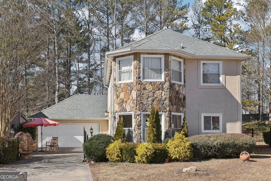 East-facing with stunning curb appeal, this spacious home is one of the largest in the community and is located in the highly sought-after Alpharetta High School district. Featuring a private gated entrance, floor-to-ceiling windows that flood the home with natural light, and a primary suite on the main level, this residence boasts wood flooring throughout. The open-concept kitchen showcases white cabinets, stone countertops, a backsplash, and stainless steel appliances. Conveniently located in the heart of Alpharetta, the home offers easy access to exceptional shopping, fine dining, and entertainment at Avalon and North Point Mall, as well as GA 400, and downtown Alpharetta Square. Nestled in a swim (salt-water pool) /tennis community, this property offers an unbeatable location in a top school district!