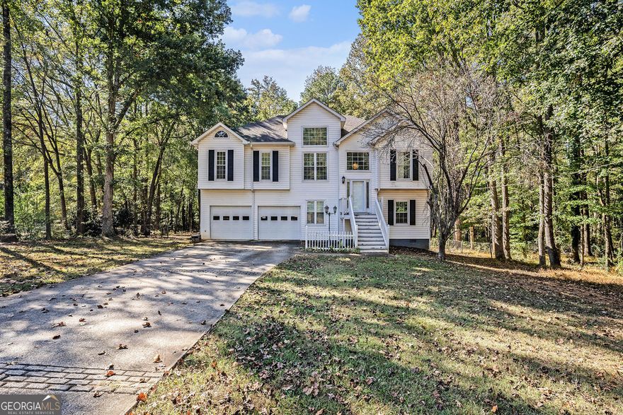 Spacious 4BR/3BA home on a private 1.79 acre lot in Locust Grove! The property offers hardwood floors, plantation shutters, and a flexible layout ideal for families or multi-generational living. The main level features a formal dining room, large family room with fireplace, and an upgraded kitchen with quartz countertops, cherry-finish cabinets, and stainless steel appliances. Enjoy the oversized sunroom overlooking the peaceful, fenced backyard, perfect for relaxing or entertaining year-round. The primary suite includes a tray ceiling, dual vanities, garden tub, and separate tiled shower. Two additional bedrooms and full baths provide plenty of space for guests. The finished lower level includes a full bath and large (4th) bonus room ideal for a teen suite, media room, office, or gym. Step outside to a huge deck, mature trees, and tons of privacy. 2-car garage with built-in storage. No HOA. Convenient to I-75, shopping, dining, and Luella schools. A rare find with land, space, and comfort, don't miss it! Southeast Mortgage is our preferred lender. If buyer chooses to work with them, Southeast Mortgage will provide 1% credit up to $5,000. Reach out to the listing agent for more information.