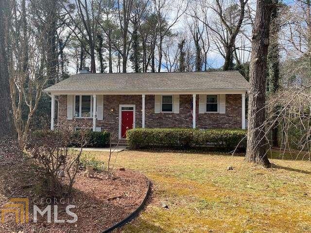 Awesome new listing with charming curb appeal in Woodridge Subdivision. This home had many updates in 2018 which include a new roof, a new sliding glass door in the dining area leading out onto your large screened porch, new flooring and new vinyl windows. The kitchen was also updated with granite countertops, custom cabinets and has newer appliances. This beauty is move in ready! The downstairs has a large fireplace and plenty of room with ground floor access from the fenced backyard. Plenty of storage is also available in the out building.
