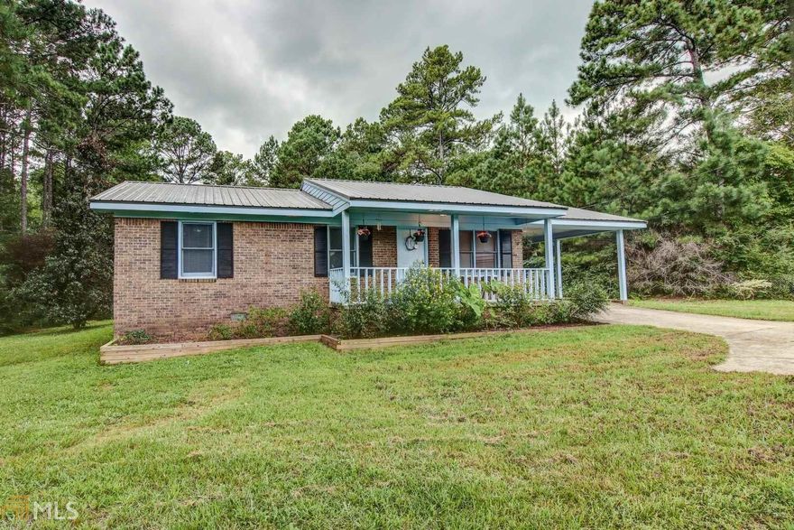 Beautiful 4 sided brick home within 3 minutes from Berry's boat dock on Jackson Lake. Completely fenced yard with additional land in the back yard. New flooring, new paint and new back deck to enjoy in the evening shade. Storage building included. Metal roof installed in 2019. No work needed, just move right in. Must see!!