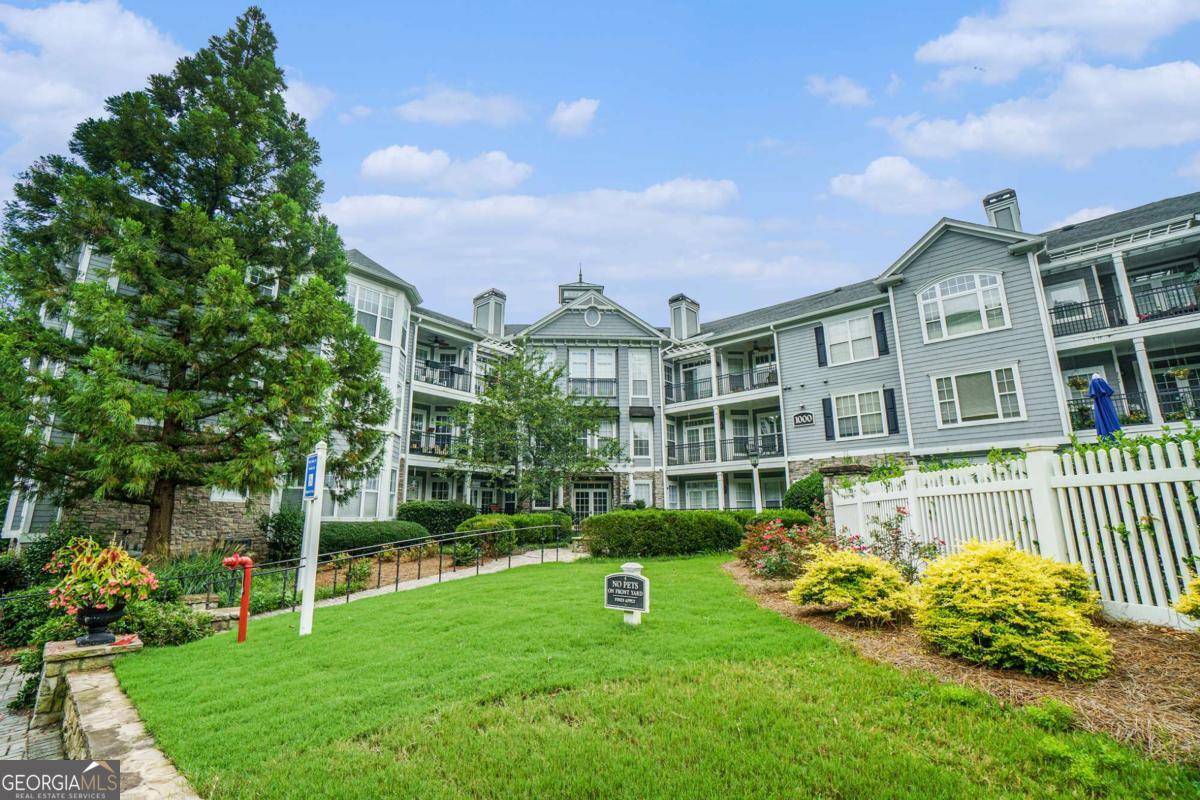 Top-Floor Vinings Condo in Gated Community! Enjoy the benefits of an Atlanta address with Cobb County taxes in this bright, top-floor unit overlooking peaceful gardens and a serene fountain. This spacious 2-bedroom, 2-bathroom condo features an open layout with a welcoming living room, cozy fireplace, and access to a private balcony-great for relaxing or entertaining. The roommate-style floor plan offers privacy, with a primary suite that includes a walk-in closet, double vanity, tub, and separate shower. The secondary bedroom has its own full bath. There's also a separate dining, in-unit laundry, and a kitchen with all appliances-including the refrigerator remaining. Extras include assigned covered parking space, private storage unit, elevator access, community pool, and fitness center. Convenient location near Truist Park, The Battery, Cumberland Mall, and quick access to I-75 and I-285. All appliances are staying that includes washer/dryer. Dog walking trail located inside the complex and access to the Silver Comet Trail is a mile away!