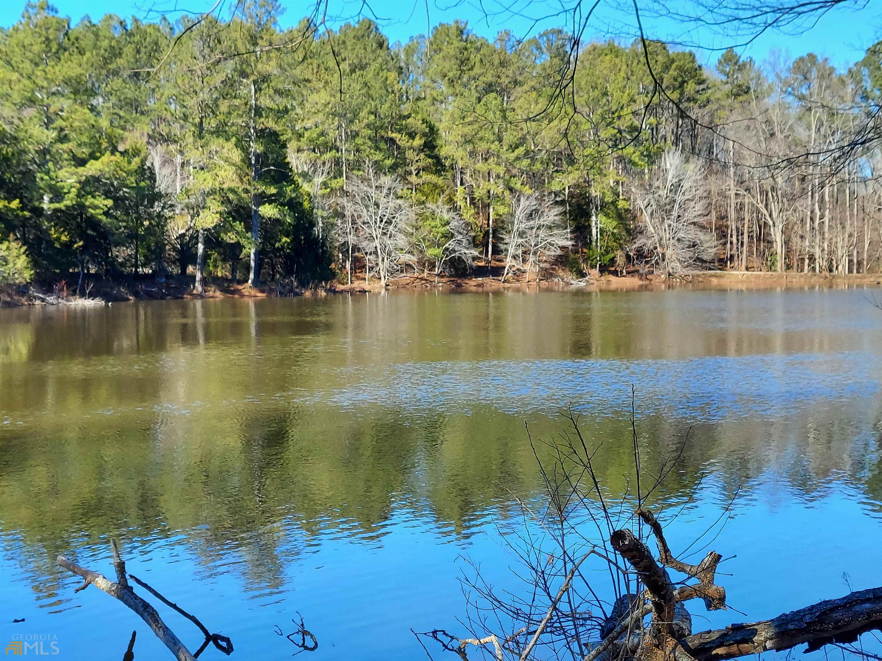 Midway between Atlanta and Chattanooga, in Bartow County. 246+ acre family-owned property, since 1950. Superb for equestrian stable estate, plus astounding development possibilities. Secluded mountain cove, bound by steep ridges, ensures ultimate privacy. 100 acres of prime pasture. 150 acres of mature timber. Pristine spring-fed lake, the wellspring of Ballard Creek. Yet within 45 minutes of Metro Atlanta. Superbly maintained 1,800 sq ft midcentury rustic retreat features heart-pine paneling, hardwood floors, upscale gourmet kitchen, all-electric HVAC. 5,000 sq ft pole barn, constructed of bridge timbers, ideal for equestrian paddocks. Countless other homesites: staggering vistas of Pine Log Mountain (east) and Fort Mountain (north). 1.5 miles of paved road frontage. Invaluable CUVA (Conservation Use Value Assessment): ten-year renewable covenant for agricultural and conservational usage, in lieu of FMV tax assessment. Utilities: Georgia Power, Bartow County water, Xfinity internet and cable, AT&T landline and fiber (ATL calling area). If you’re looking for a fabulous ready-made recreational getaway — combined with limitless development potential and property tax shelter — this is an unmatched addition to your asset portfolio.