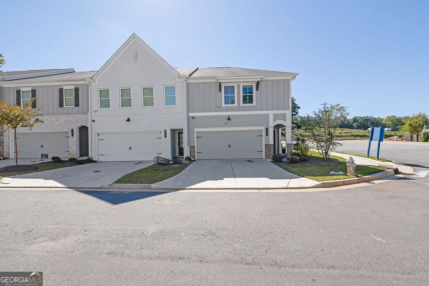 Stunning, like-new end-unit townhome located in the highly sought-after Marietta High School District! This home offers a two-car garage and features new LVP flooring throughout the main level and stairs. The open-concept main level showcases a luxury kitchen with white shaker cabinets, quartz countertops, tile backsplash, and an upgraded suite of stainless steel appliances. The kitchen overlooks the spacious living room and adjoining dining area, perfect for entertaining! A half bath and welcoming foyer complete the main level. Upstairs, enjoy a large loft area and three spacious bedrooms with ample closet and storage space. The guest bath features quartz countertops and a luxe shower. The owner's suite boasts a large walk-in closet with custom system and a spa-like ensuite featuring glass-enclosed tile shower, quartz counters, tile floors, and dual vanities. Relax on the back patio with a small yard maintained by the HOA perfect for grilling, relaxing, and pets for easy living. Community amenities include a pool, playground, fire pit, & open green spaces. Gates at Hamilton Grove community is located in Marietta near all the excitement - just minutes from extensive shopping, dining, and recreation including Whole Foods, Kennesaw Marketplace, Town Center Mall, The Marietta Square, Kennesaw Mountain Park and Kennestone Hospital! Schedule your private showing today!