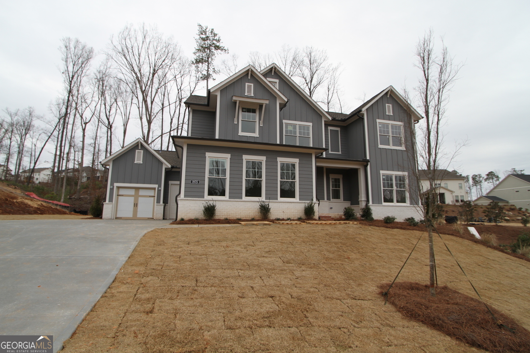 Step into this inviting Sonnett floorplan home with a charming farmhouse exterior on a unique homesite that offers endless possibilities. The side-entry unfinished basement is the perfect canvas for creating a future in-Law suite or basement apartment, making this home truly versatile. As you walk out from the main floor onto the covered patio, envision hosting gatherings and creating memories. The stunning kitchen is a true entertainer's dream with stacked cabinets, two-toned Wellborn cabinets, and GE Profile Kitchen Appliances. The full guest suite on the main floor provides a welcoming space for visitors, while the large family room with a designer electric fireplace exudes warmth and comfort. Engineered hardwood flooring flows throughout the home, with plush carpet only in the secondary bedrooms for added coziness. Upstairs, the large retreat/loft offers a perfect playroom or movie theater space, while the Jack and Jill bedroom setup and additional guest suite across the hall provide ample room for everyone. The spacious utility room adds convenience to your daily routine. At the same time, the vaulted ceiling in the owner's retreat sets the stage for a spa-like experience in the luxurious owner's bathroom featuring a Super shower. And don't forget the oversized walk-in closet for all your storage needs. This home is more than just a house - it's a place where memories are made, laughter is shared, and dreams come to life. Come and experience the warmth and comfort of this home - your perfect sanctuary awaits.