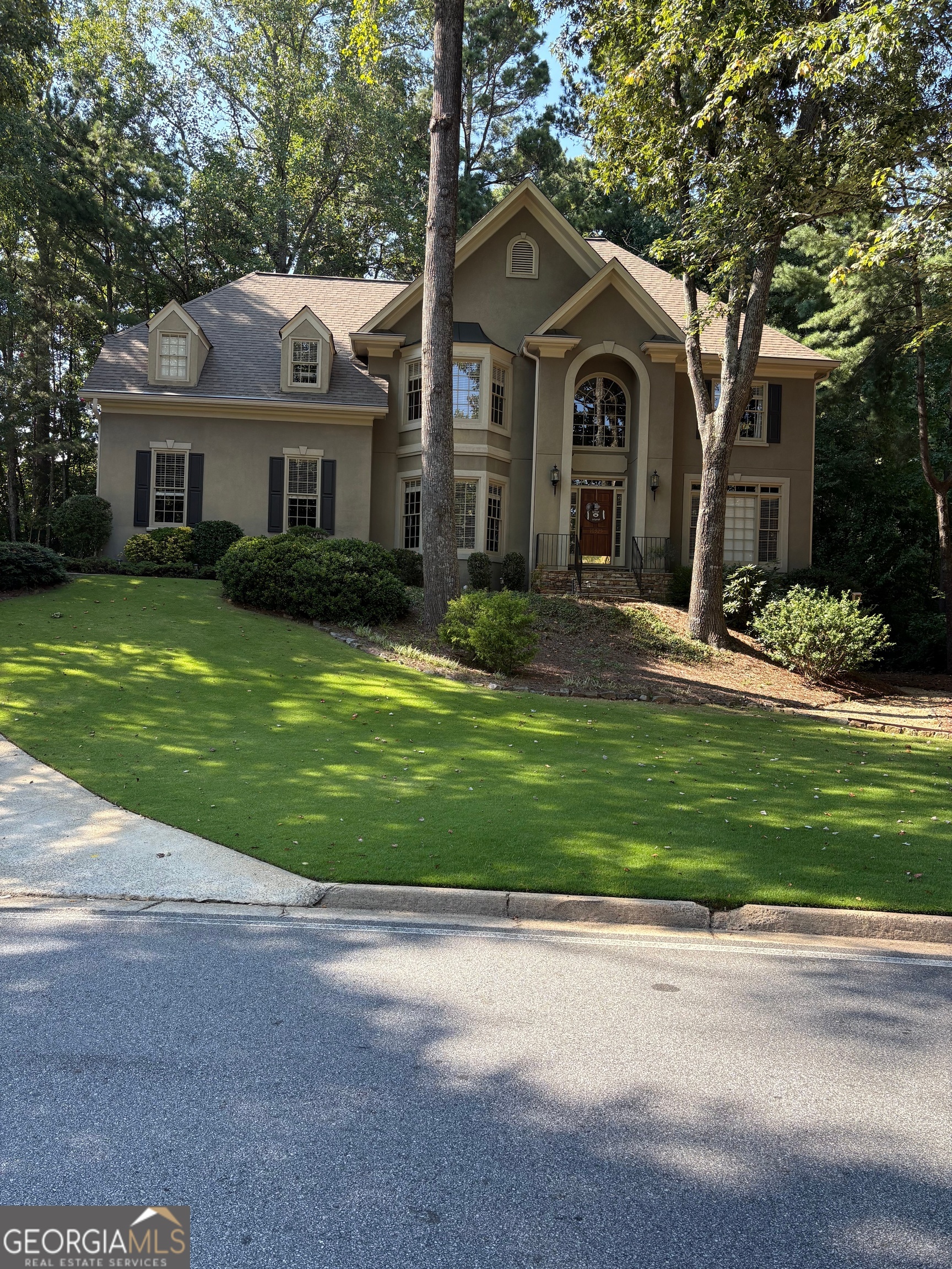 Beautiful stucco home tucked into a quiet neighborhood in Johns Creek GA with about 300 homes (Oxford Mill). The community includes such amenities as a clubhouse, pool, tennis, and pickleball. HVAC, water heater, and roof replaced within the last 10 years. Hardwoods throughout (with the exception of 2 bedrooms upstairs). Large pie shaped lot with heavily wooded backyard for maximum privacy. In close proximity to clubhouse/pool/tennis. The neighborhood does not turn over very often. It's also very close to shopping, restaurants, entertainment and several very nice city parks.