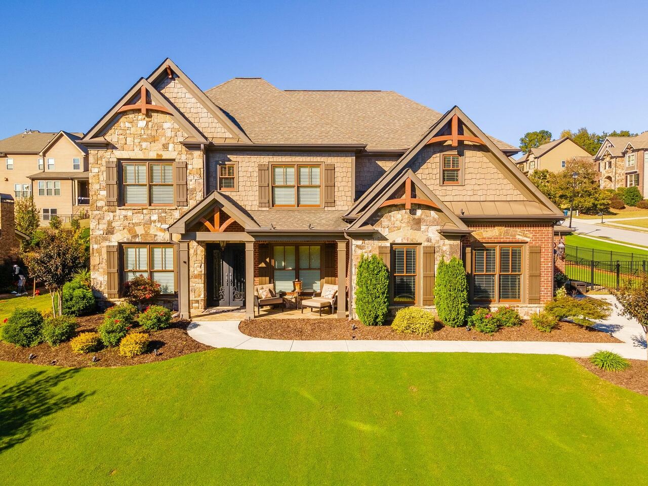 Don't miss this gorgeous home on a beautifully landscaped corner lot!! Enter the custom wrought iron doors into gleaming hardwood floors throughout most of main and in the Owners Suite ~ The layout is very open! Formal Dining Room and office/study with French doors ~ Gourmet kitchen has high end Kitchen Aid stainless appliances, an enormous island to gather around, stainless farm sink, wonderful walk in pantry and abundant cabinetry! There is a guest room and full bath on the main, additional 4 bedrooms and 3 full baths upstairs along with an open Media room~ Owners Suite has luxurious bath and good sized walk in closet ~ Other features, tiled/granite baths, upgraded trim and ceilings, drop zone when entering from 3 car garage, carriage garage is deep for a truck/SUV The yard is a show stopper!! Covered front porch and stone back patio with outdoor fireplace to enjoy these cool evenings! Located in the award winning Mill Creek School Cluster