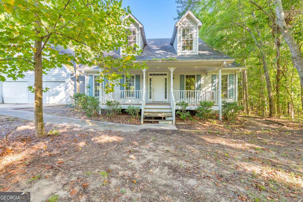 Welcome home! Nestled on a quiet, private lot on over 5 acres in the Creekside Manor North community, this 3 bedroom, 2.5 bathroom home is full of potential and ready for your personal touch. A large covered rocking chair front porch welcomes you in, leading to a traditional layout with a separate dining room and a spacious kitchen featuring white cabinets, ample counter space, a center island with seating, and a sunny breakfast room. The fireside family room boasts vaulted ceilings and great natural light. The oversized primary suite offers vaulted ceilings, an updated ensuite bathroom with a sleek glass shower and double vanities, and a walk-in closet. Two generously sized secondary bedrooms share a full bath, and a half bathroom and laundry closet complete the main level. Upstairs, a large bonus room provides flexible space for an office, playroom, or fourth bedroom. Outside, enjoy the covered back deck overlooking the serene backyard, in-ground pool, and open green space. With an attached 2-car garage and a great location close to Downtown Douglasville, I-20, the airport, and plenty of shopping and dining-this home is a rare opportunity to create something truly special. No HOA!