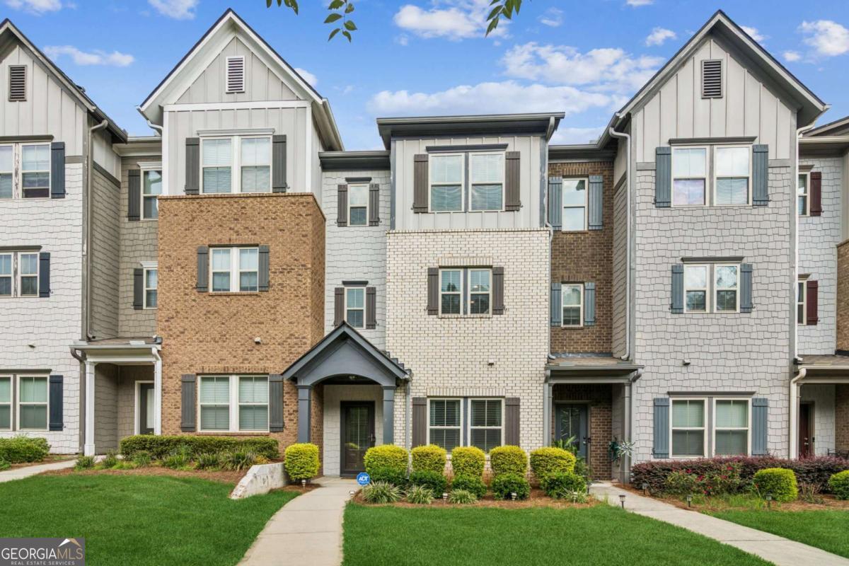 Beautifully designed, immaculately maintained tri-level townhome in coveted Lakes at Cedar Grove community! Stunning townhome features gleaming hardwood flooring, detailed crown molding. and custom designer lighting throughout. Versatile floor plan features a lower level with private bedroom, perfect for den or home office and full bathroom, ideal for guests. Upstairs, the main level unfolds into an expansive open-concept layout featuring a fireside living room, dining area with wainscoting, and eat-in chef's kitchen with center island. A sleek kitchen has painted cabinetry, granite countertops, tile backsplash, stainless steel appliances, and pantry. Bonus flex space right off the kitchen for additional dining or as currently used office nook. The private deck is accessible via French door from the living room, perfect for morning coffee or evening relaxation. Retreat to the upper level including spacious primary suite with tray ceiling and large walk-in closet, and spa bath with separate vanities, soaking tub, and separate shower. The third bedroom on this level has its own private, ensuite full bath. Private two car garage, and driveway parking. As a resident of the Lakes at Cedar Grove, enjoy access to luxe resort-style amenities including five lakes, junior Olympic pool with waterslide, pickleball and basketball courts, clubhouse, walking trails, playgrounds, and community events throughout the year. Phenomenal location walkable to shopping and dining right in the neighborhood! FHA OK! Bonus: Discounted rate options and no lender fee future refinancing may be available for qualified buyers of this home.