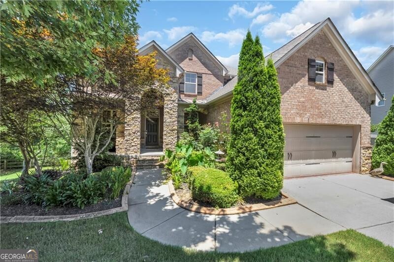 Welcome home to charm, comfort, and convenience-all just minutes from GA 400, downtown Roswell, parks, and endless shopping and dining options. This beautifully crafted brick and stone residence offers timeless curb appeal and welcomes you with a gracious covered front porch. Step inside to a two-story foyer flanked by a light-filled living room-perfect for a home office-and an elegant formal dining room ideal for entertaining or intimate dinners. The spacious great room features a vaulted ceiling, cozy fireplace, and seamless flow into the open-concept kitchen and breakfast area. The kitchen is a chef's delight with granite countertops, stainless steel appliances, and a five-burner gas cooktop. A main-level bedroom and full bath provide a perfect guest retreat or in-law space. Upstairs, the oversized primary suite offers a relaxing escape with a spa-inspired bath including a whirlpool tub, dual vanities, and two large walk-in closets. Three additional bedrooms and a full bath complete the upper level. The terrace level includes a home gym with mirrored wall and professional flooring, a media room for movie nights, and a generous unfinished area ready for your personal touch-whether it's a home office, playroom, or wine cellar. Additional highlights include on-trend lighting, wood blinds throughout, and professionally landscaped grounds. This move-in ready home is a rare find in a sought-after location-schedule your private showing today!