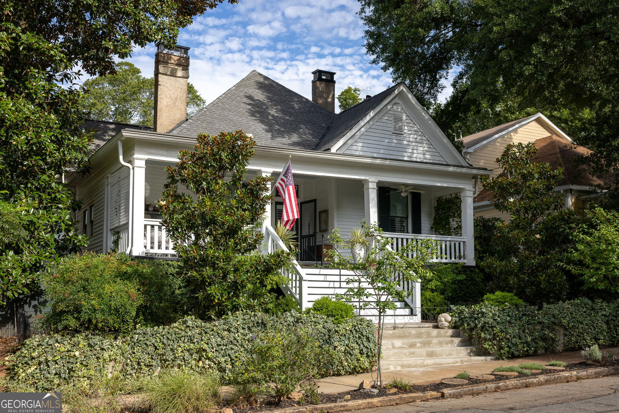 Simply iconic. A front porch fit for Southern royalty welcomes you to a home that has graced Atlanta's history for more than a century. Lovingly restored, it blends historic soul with modern comfort at every turn. Inside the central hall, heart pine floors stained a dramatic black run beneath soaring 11-foot ceilings. The original 3-bedroom, 2-bath layout now lives as a 2-bedroom with a private primary suite, featured in Atlanta Magazine (May 2025). The former third bedroom serves as an elegant parlor, while the spacious primary retreat offers a private bath, custom closet, and direct laundry access. At the back of the home, the custom kitchen features quartz countertops, floor-to-ceiling cabinetry, LG appliances, gas stove, and designer lighting. An inviting eat-in area flows to the conservatory through double French doors, framed by Pella custom windows. The interiors are elevated by one of the most complete private collections of mid-century modern furniture and art in Atlanta, featuring pieces by Knoll, Eames, Nelson, and McCobb, curated with the precision of a design museum, yet intended for everyday living-select pieces will be available to purchase. The stand-up unfinished basement provides abundant storage, enhanced with federally approved Lexan windows. Now the outdoor oasis, a 16 36 heated saline pool and jacuzzi (Maliblue of Serenbe, 2019) anchor a Brendan Butler designed garden, shaded by three prominent live oak trees, and secured with an automatic gated entry. Renovated top-to-bottom in 2019, updates include: New architectural shingle roof-New HVAC-Whole-house vacuum system-All-new wooden windows with custom shutters and shades-Custom kitchen, Custom Laundry and Pantry (Full list of renovations available upon request) The 2021-built pool house is a one-bedroom, one-bath retreat with a kitchen, polished concrete floors, interior and exterior shower, front pool closet, rear workshop, and its own whole-house vacuum system. A rare opportunity to own a residence that pairs turn-of-the-century craftsmanship with high-end modern updates plus an incomparable mid-century furniture and art collection, ready for its next steward. Come on in, Precious.