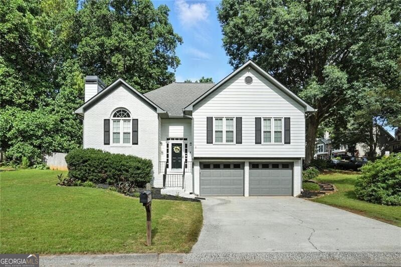 This could be your new home! Like new, charming Woodstock home in the swim/tennis neighborhood of Wellington Manor so close to highways, shopping and downtown Woodstock! Renovated and maintained to perfection this home has so much to offer: new kitchen, new master bath vanity, gorgeous hardwood flooring, new carpet in bedrooms, smooth ceilings and newer windows! Oversized fireside great room with vaulted ceiling and large palladium window. Formal dining space. Completely renovated kitchen filled with natural light, views of the fenced back yard and it offers a generous eating area with built-in window seats. White cabinets, stainless appliances, granite counters! Lavish master suite with walk in closet and custom trim work and tray ceiling. Large secondary bedrooms and an updated hall bath with granite vanity. Lower level offers a movie room with projector, a game room or man cave and tons of storage and there is an awesome workshop (could be a gym, wine cave, make it what you need) in the oversized garage. This is a fabulous floor plan. Rear yard offers a large storage shed for garden tools, or would make a great playhouse. This is a must see home.