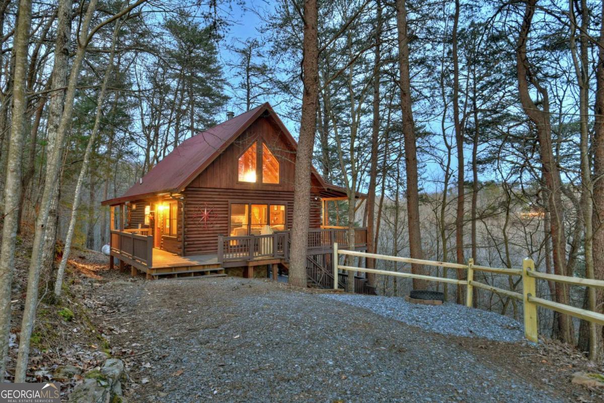 CAN YOU SAY VIEW? Are you looking for a mountain getaway or one that has great rental income? This 2 bedroom, 1 bath cabin in Cherry Log has it all!! You are certain to love sitting on the deck enjoying the cascading mountain views. Located a short distance from downtown Blue Ridge this one is a MUST SEE! Charming interior with a wood-burning fireplace and plenty of windows and natural light. Fully furnished and turn key with future bookings.