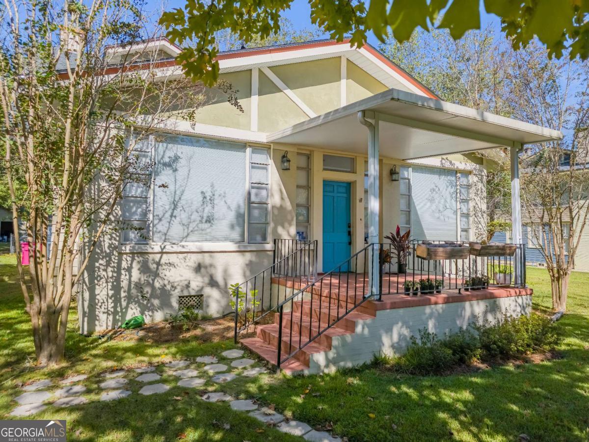 Historic Charm Meets Modern Comfort - 4 Bed, 3 Bath Beauty on Half an Acre This stunningly restored 4-bedroom, 3-bath home offers timeless character blended seamlessly with modern updates-truly move-in ready and full of thoughtful details throughout! Step inside and be greeted by original heart-pine wood floors, soaring 10-foot ceilings, cased openings with original pocket doors, and two inviting living areas. The layout also includes a home office, formal dining room, and a spacious eat-in kitchen-perfect for both entertaining and everyday living. Located on a rare half-acre lot in the historic district, this property features an oversized two-car garage with epoxy floors (a true rarity!) and a spacious carriage house ideal for storage, a workshop, or future expansion. The backyard oasis includes a deck, charming gazebo, and plenty of room to create the garden of your dreams. The sunroom at the front of the home is a standout, featuring restored original windows that flood the space with natural light. The cozy main living room offers a brick fireplace, and is separated from the office by pocket doors. The office itself boasts a built-in bookshelf wall and wet bar. Another set of pocket doors leads to the elegant dining room with original wood trim. The updated kitchen features new flooring, granite countertops, tile backsplash, new lighting, and brand-new stainless appliances. The main-floor primary suite includes a brand-new en-suite bath and walk-in closet. An additional large bedroom and updated guest bath complete the first floor. Upstairs, you'll find two more spacious guest bedrooms, a third updated full bath, a built-in desk nook, and walk-out access to a partially finished attic-perfect for extra storage or potential expansion. Major Updates Include: Electrical & plumbing updated New tankless water heater (2024) Upstairs HVAC (2018), downstairs HVAC (2020) New roof (2018) Every inch of this home has been lovingly restored and thoughtfully updated-ready for its next chapter. Fun Fact: Built in 1905 by Henry Harding-Tift for his lumber foreman, it's said the foreman hand-selected each piece of wood-so meticulously, you'll be hard-pressed to find a single knothole in the floorboards! Call today to schedule a private tour of this Historic Gem!