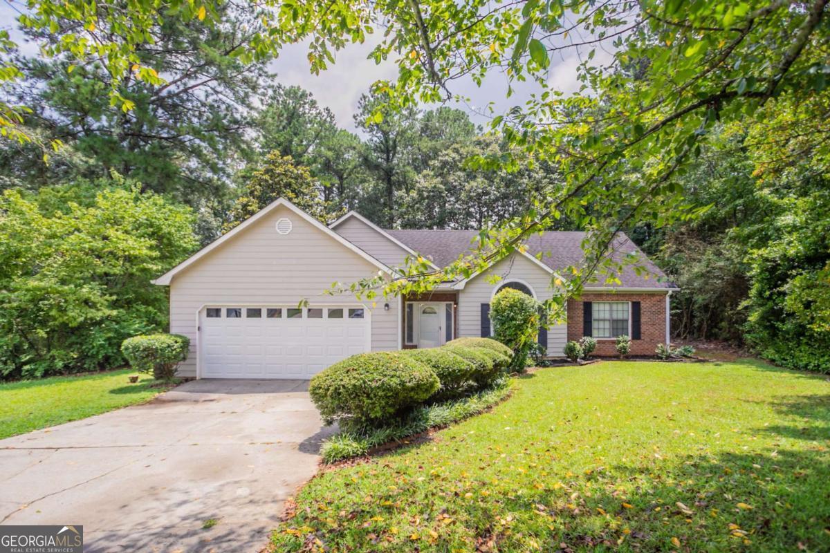 Welcome to this charming 3-bedroom, 2-bath ranch-style home located in the established Panhandle Plantation community. Featuring a freshly painted interior, the home offers a spacious great room with a brick fireplace, a functional kitchen with stained cabinets and laminate countertops, and a cozy dining area. The primary suite includes a separate tub and shower along with a walk-in closet. Enjoy outdoor living on the oversized deck or relax in the screened-in porch-perfect for morning coffee or evening unwinding. This property sits on a private, half-acre lot with mature trees and plenty of outdoor space. Ideal for those seeking a comfortable, one-level layout in a quiet neighborhood near local shopping, schools, and main commuter routes. Schedule a showing today! One or more photos have been virtually staged.