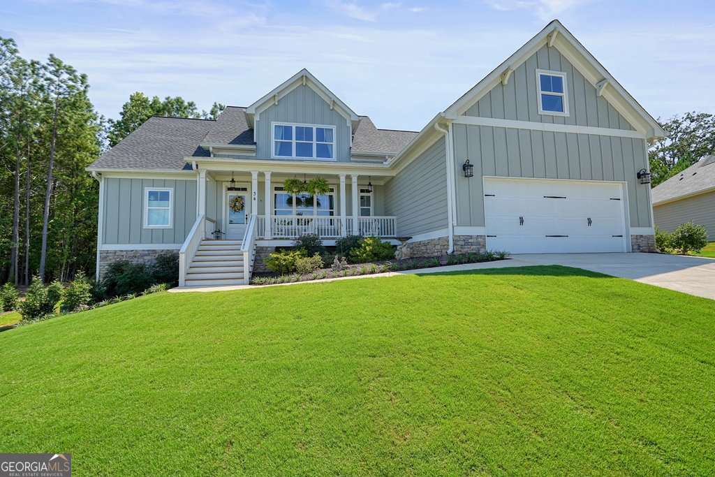 This stunning almost new ranch home with builder upgrades throughout combines timeless design with modern comforts and is move-in ready. From the welcoming front porch to the covered back deck, every detail invites you to relax and enjoy. Featuring your own private saltwater inground pool with cleaning system and cover, this meticulously maintained 3-bedroom, 2.5-bath home with a versatile bonus room/Loft that can easily serve as a 4th bedroom with its own bathroom is a true standout. For added flexibility, the full unfinished daylight basement awaits your personal touch, whether you're looking to expand your living space, design the perfect workshop, or create a home gym. Inside, the open-concept layout showcases gleaming hardwoods in the foyer, dining room with coffered ceilings, kitchen, living room, and pantry, crown moulding, and windows that fill the space with natural light. The chef's kitchen features stainless steel appliances, granite countertops, soft close cabinets with the open concept living and dining areas that provide the perfect backdrop for gatherings with family and friends. The recently added sunroom off the kitchen offers even more entertainment space or just a space to relax. The main-level primary suite is a private retreat with 9-foot coffered ceilings, a spa-like bath featuring a freestanding tub, a tiled shower with bench, and elegant finishes throughout. Two additional bedrooms are located on the main level with a tiled Jack and Jill bath, and a fourth bedroom and full bath option upstairs offering flexibility for a home office, guest suite, or creative space. Outdoor living is equally inviting, with a covered back patio perfect for morning coffee or evening entertaining with its landscaped backyard and inground saltwater pool. Conveniently located just 15 minutes from shopping, dining, grocery stores, and Downtown Cartersville, this like-new home offers both style and functionality in a sought-after community.