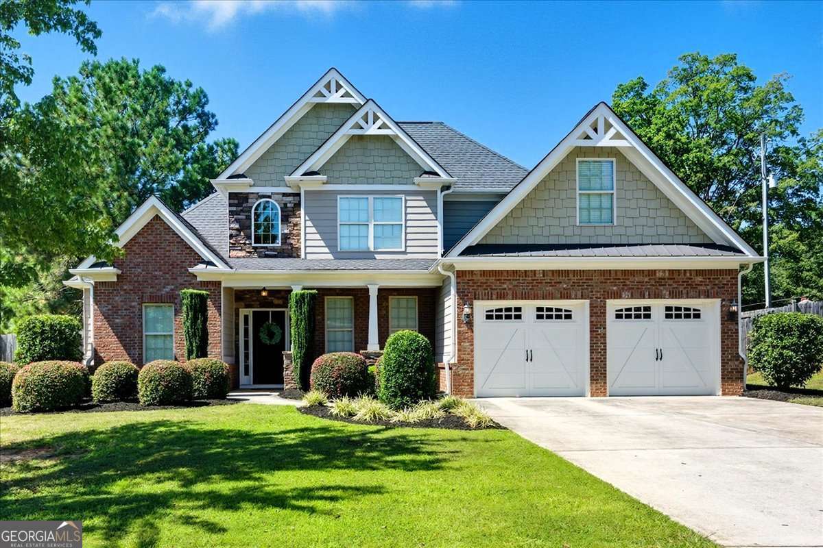Welcome to this beautifully designed open-concept home that truly has it all! Enjoy gleaming hardwood floors throughout the main living areas, a spacious dining room, and a main-level primary suite complete with a large walk-in closet. The kitchen features stained cabinetry, granite countertops, stainless steel appliances, a pantry, and opens to a generously sized breakfast area and a spacious two-story family room, perfect for entertaining. The main level also includes a convenient laundry room. Upstairs, you'll find two generously sized bedrooms that easily accommodate queen beds, plus a versatile bonus room ideal for a home office, guest room, gym, or media space. Step outside to the screened-in patio, perfect for morning coffee or relaxing evenings, all overlooking a large, fenced backyard. Located just minutes from shopping, dining, and award winning schools. Best of all, no HOA!