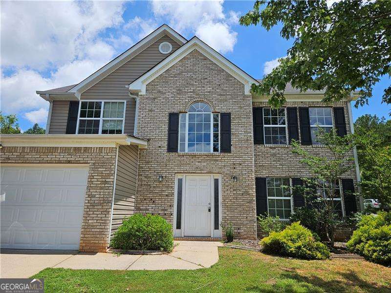 BRAND NEW ROOF, new front door, kitchen appliances and fresh interior paint! Well maintained home on corner lot Tanger Ridge located on Locust Grove Georgia. This brick front home has a tall wooden privacy fence at the back, large rooms and plenty to offer. As soon as you step inside you're greeted by formal two story foyer with views into the living room. Living and dining combo is ideal for entertaining. Kitchen includes stained cabinets, kitchen island, wine rack and tons of storage. Eat in breakfast room overlooks the family room and backyard. Fireside family room has fireplace at the center with plenty of natural light and luxury vinyl plank floors. Primary suite includes tray ceilings, private bath with double vanities and separate tub/shower. Primary suite includes large walk in closet as well! Three more well sized bedrooms make up the second floor and share a full bath. Backyard is fully fenced flat & grassy! Located behind Tanger Mall Outlet, near shopping, restaurants, major highways and more.
