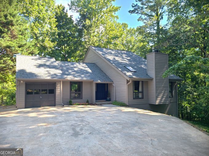 South Lake Lanier Waterfront Retreat - Move-In Ready! Welcome to your dream lakefront lifestyle in Cumming! This beautifully renovated 3-bedroom, 2.5-bath home sits in one of South Lake Lanier's most coveted locations-just minutes from GA-400, top dining, shopping, and marinas. Completely updated in 2023, this home is designed for both relaxation and entertainment. A brand-new single slip party dock with stunning sunset views awaits in a peaceful cove, with golf cart access from your own dedicated storage space. Inside, the main level features a primary suite with sweeping lake views, a soaring two-story family room with a stone fireplace, a flexible dining/office space, and a stylish granite kitchen with all-new stainless-steel appliances, pantry, and renovated laundry room with a new washer/dryer. Step out onto the spacious deck or soak in the hot tub while taking in the water views. Upstairs, two oversized bedrooms share a full bath, each with lake views of its own. The finished terrace level offers the ultimate hangout space-perfect for a second family room, game room, home theater, or lake weekend entertaining-plus an additional garage for golf cart or water toy storage. No detail was overlooked: new flooring, roof, HVAC, water heater, paint (inside & out), laundry room, deck, and fully updated kitchen and baths. This home is the perfect blend of luxury, convenience, and lake living-just bring your boat and start making memories. South Lake properties like this don't last.