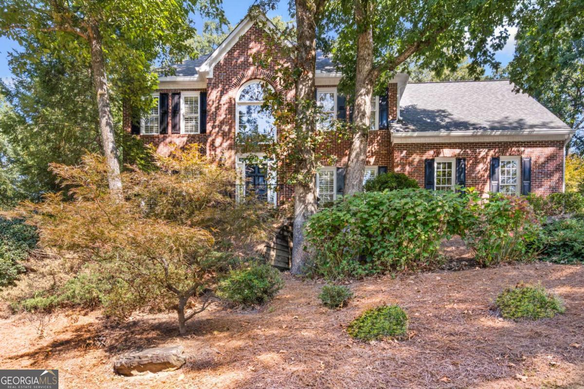 Welcome to your new home in the highly sought-after Foxhall subdivision! This beautifully maintained 3-sided brick home offers a perfect blend of charm, function, and space for everyday living and entertaining. Step into the two-story foyer with gleaming hardwood floors, flanked by a cozy sitting room on one side and a formal dining room on the other. The bright, open family room features a gas fireplace and flows seamlessly into the airy kitchen -perfect for gatherings. You'll love cooking in this open kitchen with stainless steel appliances, large island, and granite counters. Upstairs, retreat to the spacious primary suite with double closets and vanities, while three additional bedrooms-each with plantation shutters-share a well-appointed bath. The finished basement adds incredible versatility: a freshly painted rec room ready for movie nights or playtime, plus a bonus room ideal for an office, home gym, or workshop. And yes-there's plenty of storage, too! Step outside and enjoy your private, fenced backyard oasis. A deck off the kitchen overlooks an expansive hardscape and lush, professionally landscaped yard with the perfect balance of sun and shade. Whether hosting friends, gardening, or letting kids and pets run free, this space has it all. This home is truly move-in ready-and here's a fun fact: Alton Brown from Good Eats once cooked and filmed in this very kitchen! Foxhall offers a vibrant, active lifestyle with swim, tennis, pickleball, playground, greenspace, and clubhouse. You'll also have the option to join Settindown Creek Golf Club at Ansley Golf Club, located right in the neighborhood. All of this plus top-rated schools (Sweet Apple Elementary & Roswell High) and convenient access to shopping, dining, and entertainment in Roswell, Woodstock, and Alpharetta.