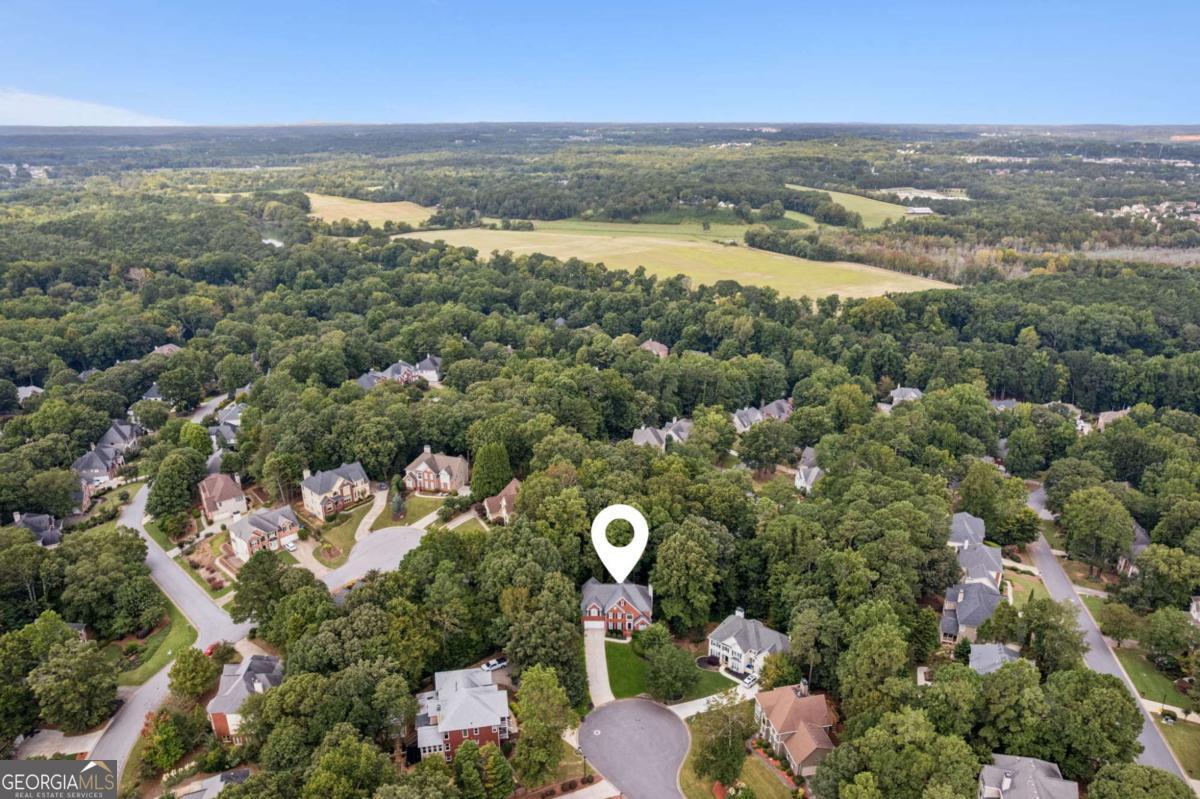 Welcome to your new home in the sought-after River Plantation swim and tennis community, with neighborhood trails leading to the Chattahoochee River. Tucked away on a quiet cul-de-sac, this 5-bedroom home is zoned for the award-winning Peachtree Ridge High School and Hull Middle, offering both convenience and lifestyle. Inside, the main level is filled with natural light and overlooks a private wooded backdrop. A two-story foyer opens to a formal dining room perfect for gatherings and a versatile sitting room ideal for an office. The living room's tall ceilings create an elegant yet inviting atmosphere, seamlessly connected to the kitchen for effortless entertaining. Step outside to the spacious deck-perfect for morning coffee and deer watching. Upstairs, the oversized primary suite features dual closets and a large bath, while three additional bedrooms provide plenty of space for family, guests, or home offices. The finished basement expands the living area with its own private deck and fire pit, a full kitchen, living room, flex room, and bedroom-making it ideal for movie nights, entertaining, or multi-generational living. Lovingly maintained with updated Trane HVAC systems, this home is move-in ready and offers abundant storage throughout, accommodating even the largest households. Enjoy easy walks to the newly renovated Roger's Bridge Park and Chattapoochee Dog Park. Looking ahead, the exciting Gas South District expansion promises Gwinnett's very own Avalon-style destination just ten minutes away. With a prime location right off Peachtree Industrial, you'll have quick access to I-85, downtown Duluth, Suwanee, and Johns Creek-making this home the perfect blend of comfort, convenience, and community. Lovingly maintained with replaced HVAC systems, this home is move-in ready and offers abundant space and storage throughout-perfect for even the largest household.