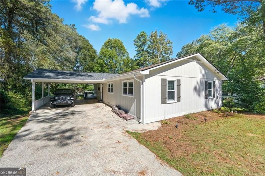 Welcome to 2011 Shadowood Drive, a beautifully updated ranch tucked away on a peaceful half-acre lot in Marietta's highly desired Shadowood community.  Step inside to find a bright, open layout filled with natural light from brand-new energy-efficient windows. The cozy new fireplace adds warmth and character, while the finished basement offers versatile space perfect for a home office, media room, gym, or guest area. The owners have invested in major updates for long-term peace of mind, including a new GAF architectural shingle roof, a new HVAC system, and 16 double-pane windows. Location is everything here, minutes from I-75, shopping, dining, and parks, yet nestled in a neighborhood that feels tucked away from the hustle and bustle.  Families appreciate access to Addison Elementary, Simpson Middle, and Sprayberry High, all top-rated schools in the area. Whether you're drawn to the modern upgrades, the quiet setting, or the unbeatable location, 2011 Shadowood Drive offers the perfect blend of convenience and comfort, ready for you to move in and make it your own.