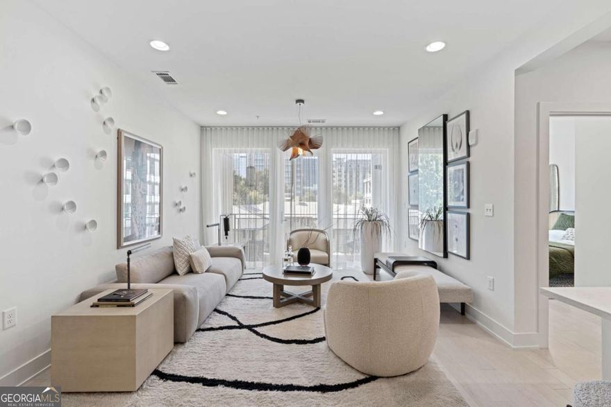 Welcome to your new home at J5, new luxury condominiums in the heart of Midtown! J5 offers ultimate Intown living: quality construction, convenient location, unmatched service, and luxurious amenities. This 2-bedroom, 2-bathroom home features an open-concept living and dining area, Midtown skyline views, and abundant natural light. This home is beautifully designed to maximize its space and boasts 2 complete bedroom suites. The primary suite has an attached private balcony, the perfect way to greet the day with your morning coffee or unwind while overlooking the picturesque Midtown skyline. Both bedroom suites have a sizeable walk-in closet, dual-sink vanities, integrated light mirrors, contrasting cabinetry with full overlay flat panel doors, and soft close features. State-of-the-art finishes continue throughout the home with wide plank hardwood flooring, KitchenAid appliance packages with gas cooking, and quartz countertops. Unwind on one of your balconies or head down to one of two clubrooms for fireside chats with neighbors. Soak up the sun next to the saltwater pool, or head over to the garden deck to pick fresh herbs for your home-cooked meal in your chef-inspired kitchen. Luxury conveniences continue with a 24-hour concierge, state-of-the-art fitness center, pet spa, and an open-air rooftop lounge!