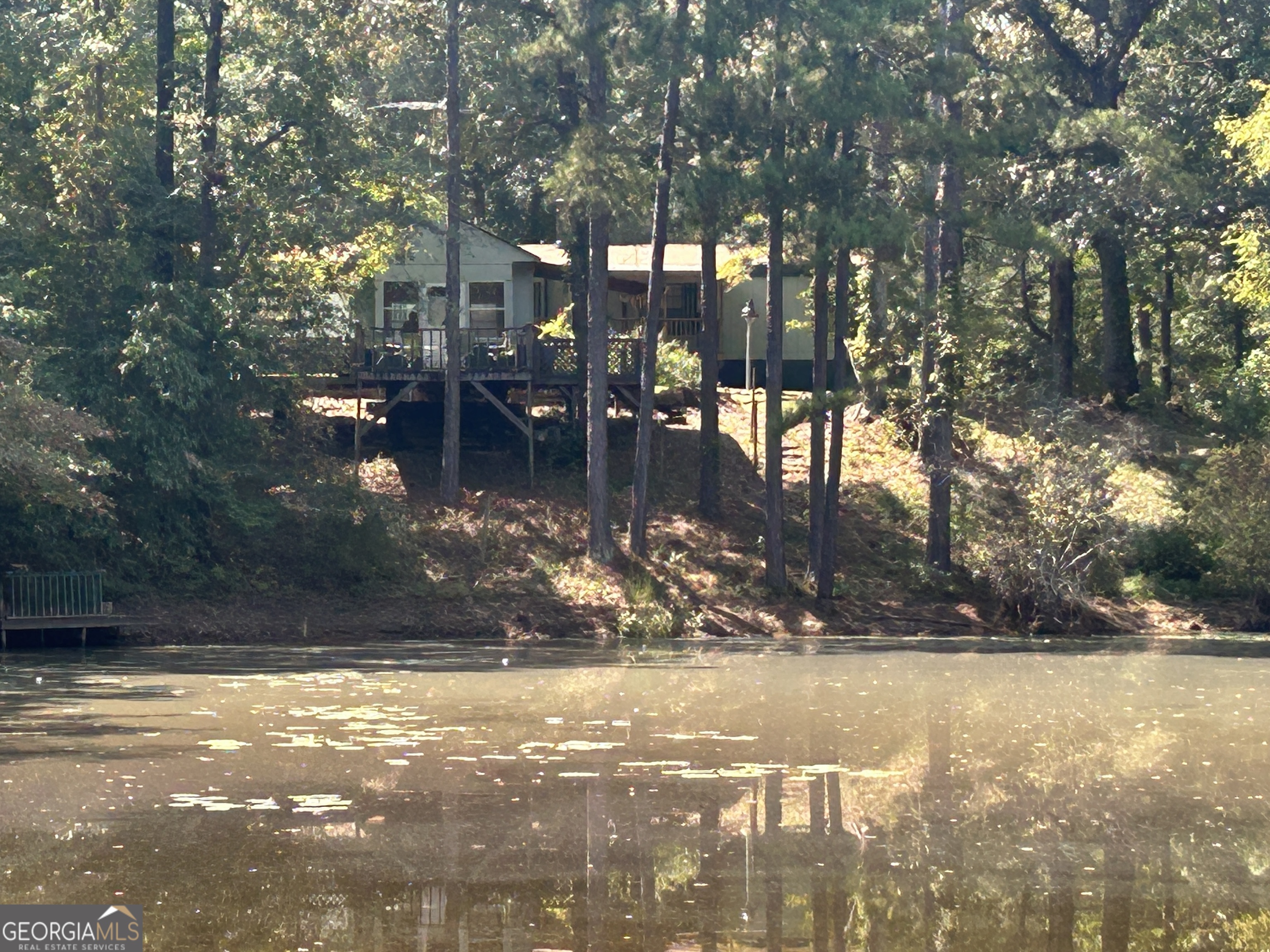 Just outside the city limits, within Monroe County, sits 12 wooded acres with a Private Stocked Pond of your own, a tiny home & a fish cook house with decks to fish from! What a great place to buy for family gatherings, fish frys, a retreat away from home, or your own little hunting tract. 2024 Roof, New Kitchen Cabinets, 2019 Trane HVAC System. You're all good to go! All you need to bring is your fishing rod, deer rifle, & side by side for your own private retreat! Would make a great week-end get-a-way or a perfect place to retire!