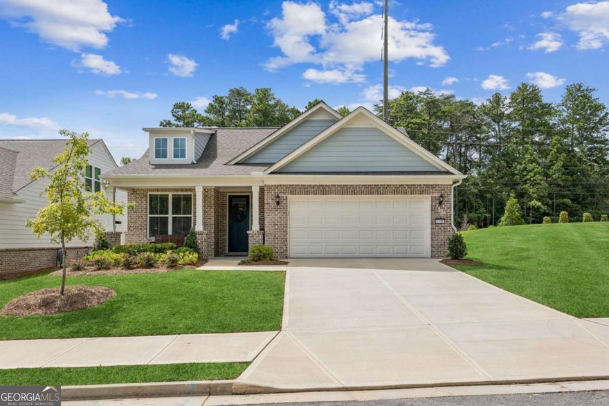 .5% interest rate reduction with preferred lender for one year on conventional loans! Ask us how. Ready to downsize? This like-new ranch in Buford offers one-level living in a location that can't be beat-just a short walk to Lake Lanier parks and walking trails, 10 minutes to downtown Buford and Sugar Hill, and 15 minutes to Suwanee or Cumming. Close to all the shopping and dining you could want at the Cumming Marketplace, yet tucked away in a peaceful, country-like setting. Pulte's popular mainstay floorplan features an open layout with kitchen, dining, and living spaces together, plus a front office overlooking the street. The patio and walkout backyard provide space for grilling or gardening. Inside, updates include crown molding, an oversized quartz island, neutral flooring, 5" baseboards, soft-close drawers, walk-in pantry, and a contemporary hooded vent over the cooktop. The spacious primary suite is a true retreat, featuring a large walk-in closet and a luxurious bathroom with an oversized frameless glass shower enclosure and custom tile. Bright and move-in ready, this home is part of Lakecrest, a 55+ community that include landscaping-perfect for those who want low-maintenance living without paying for extra amenities they won't use.