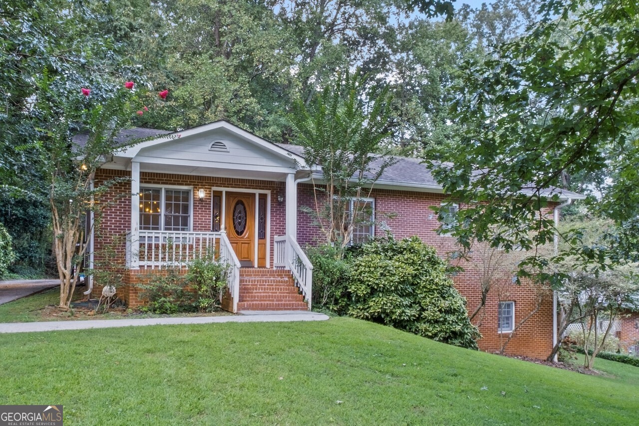 Welcome to this one-of-a-kind Marietta home that combines lodge-style character with modern comfort and incredible space. Rebuilt in 1996, this property delivers the charm of soaring cathedral ceilings with exposed beams, a dramatic stone fireplace, and gleaming hardwood floors throughout the main level. The open-concept design flows seamlessly into a chef's kitchen featuring a Sub-Zero refrigerator/freezer, 6-burner Dacor gas cooktop with commercial vent hood, Asko dishwasher, Corian countertops, and a central island perfect for everyday living and entertaining. With 3 bedrooms and 3 full baths, this home balances cozy retreats with flexible living. The highlight is the fully finished terrace level, offering a huge multi-purpose room, a full bathroom, and a dedicated projector/movie room an entertainer's dream that can also flex as an in-law suite, teen hangout, or private office. Car enthusiasts and hobbyists will love the oversized 4-car carport with RV/boat parking, a rare find in this market. The spacious lot provides room to spread out while still being just minutes from Powers Park, Cobb Parkway shopping and dining, and major commuter routes. This home is more than just a place to live it's a lifestyle. From movie nights in your private theater to gatherings under vaulted ceilings, 402 Terrydale is designed to impress.