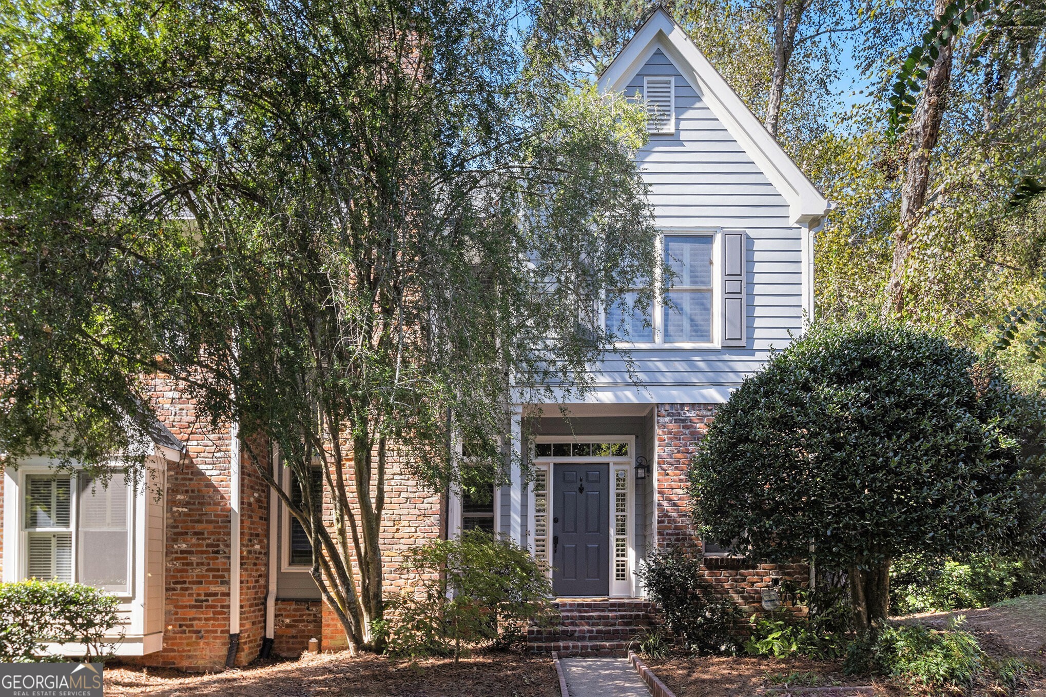 End-Unit Townhome in Sought-After Riverwalk - Steps from the Chattahoochee River and Scenic Nature Trails! Discover the perfect blend of nature, lifestyle, and luxury living in this Stunning End-Unit Townhome located in one of Roswell's most desirable communities Riverwalk. Nestled along a private neighborhood trail and with easy access to the Chattahoochee River and the Roswell Boardwalk, residents enjoy easy access to the Chattahoochee Nature Center, Vickery Creek Falls, and top hiking spots like The Mill Trail. Spend weekends exploring the outdoors or grab a coffee from Land of a Thousand Hills before hitting the trails just steps away. Step inside through the Foyer Entrance to find Hardwood Floors and Wooden Shutters that flow throughout the light-filled home. The Chef's Kitchen impresses with Granite Countertops, Tile Backsplash, Stainless Steel Appliances, and a Breakfast Bar that opens to a cozy Fireside Breakfast Room. Continue into the Open-Concept Living Area, where a Family Room with a Fireplace and a Dining Room framed by Picture Windows lead to the Private Rear Deck perfect for morning coffee or Al Fresco Dining surrounded by trees. Upstairs, retreat to the Primary Suite boasting a Tray Ceiling, Custom Walk-In Closet, and a Spa-Inspired Ensuite Bath with Dual Vanities, a Modern Soaking Tub, and an Oversized Tiled Shower with Rainfall Showerhead and bench seating. Two additional bedrooms share a stylish Hall Bath with an extended vanity. The Fully Finished Basement offers endless flexibility featuring a Large Entertaining Room with Wet Bar, an additional Bonus Room, and a Full Bathroom perfect for a home theater, office, or guest suite. Enjoy serene views and privacy from the Expansive Rear Deck overlooking a wooded area. This Certified Wildlife Habitat offers the rare opportunity to live immersed in nature while still being minutes from shopping, dining, entertainment, and parks with easy access to GA-400 and I-285. This Riverwalk gem truly captures the ultimate Roswell lifestyle where urban convenience meets natural tranquility.