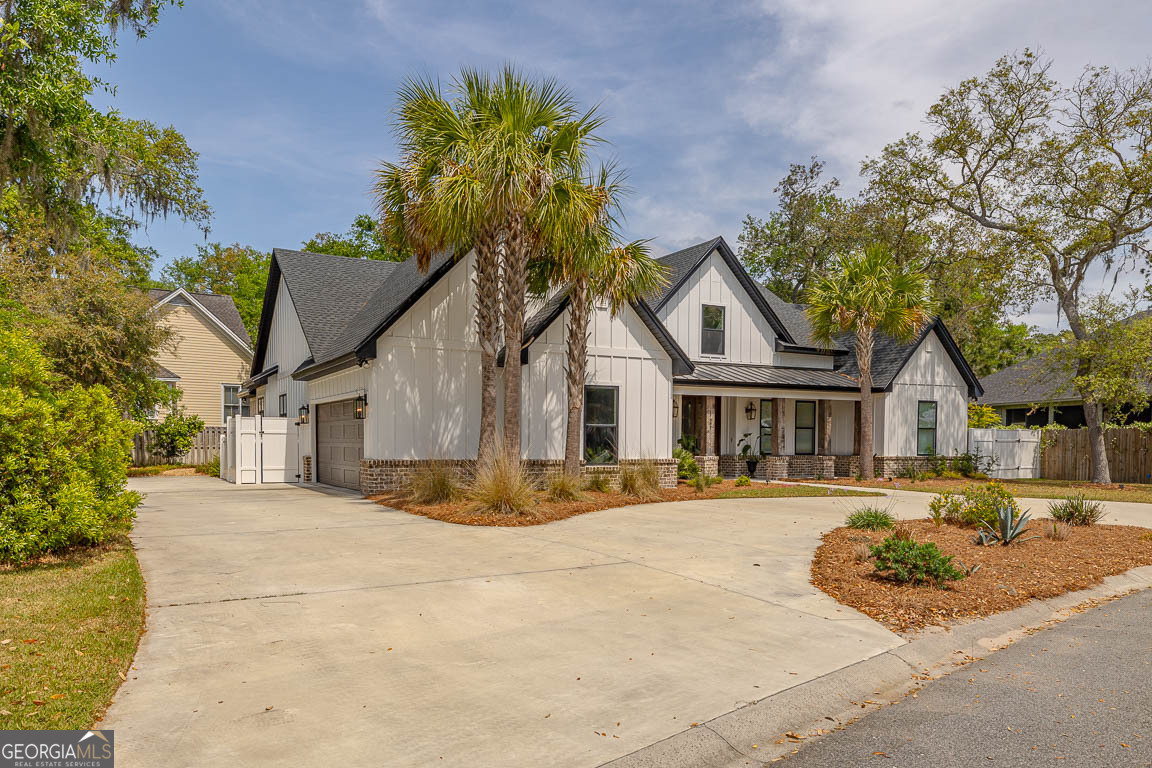 Escape the noise to a newly built custom 3 bed/3.5 bath home in one of St Simons Island's premier gated community of West Point. Certificate of Occupancy received March 29, 2023. Lot is NOT in a flood zone - no flood insurance required. The large gas lanterns provide a warm greeting when you pull up to the front porch on the semicircular driveway. This home features 3 bedrooms each with an ensuite bathroom. Either one of the two offices could be converted to a bedroom (both rooms have a closet). Bonus Room upstairs with attic storage. The thoughtfully designed open-concept floor plan is great for both everyday living and entertaining. 10-foot ceilings and 8-foot doors throughout. The living room boasts a vaulted ceiling with wood beams, creating a warm and inviting atmosphere. A custom hood vent highlights the beautifully designed custom kitchen. The pantry has ample storage. The primary bathroom has his and hers vanities with a stand-alone soaking bathtub and large shower. The back porch is ideal for gatherings - featuring an outdoor kitchen and wood burning fireplace. The home is equipped with 2 HVAC units and spray foam insulation throughout. The bonus room above the garage has its own thermostat as well. The house is pre-wired for a future pool. Propane tank is used to run the front porch gas lanterns, gas grill, Blackstone grill, and gas starters for both fireplaces. West Point is a well-designed neighborhood with 12+ acres of lakes, 7+ acres of parks and oak lined streets. Amenities include clubhouse, pool, playground and street lights with multiple exit points for easy access. This home offers the peace and privacy of Saint Simons north end, while still being close to everything the island has to offer. Don't miss this rare opportunity to own a stunning custom home in one of the island's most sought-after locations!