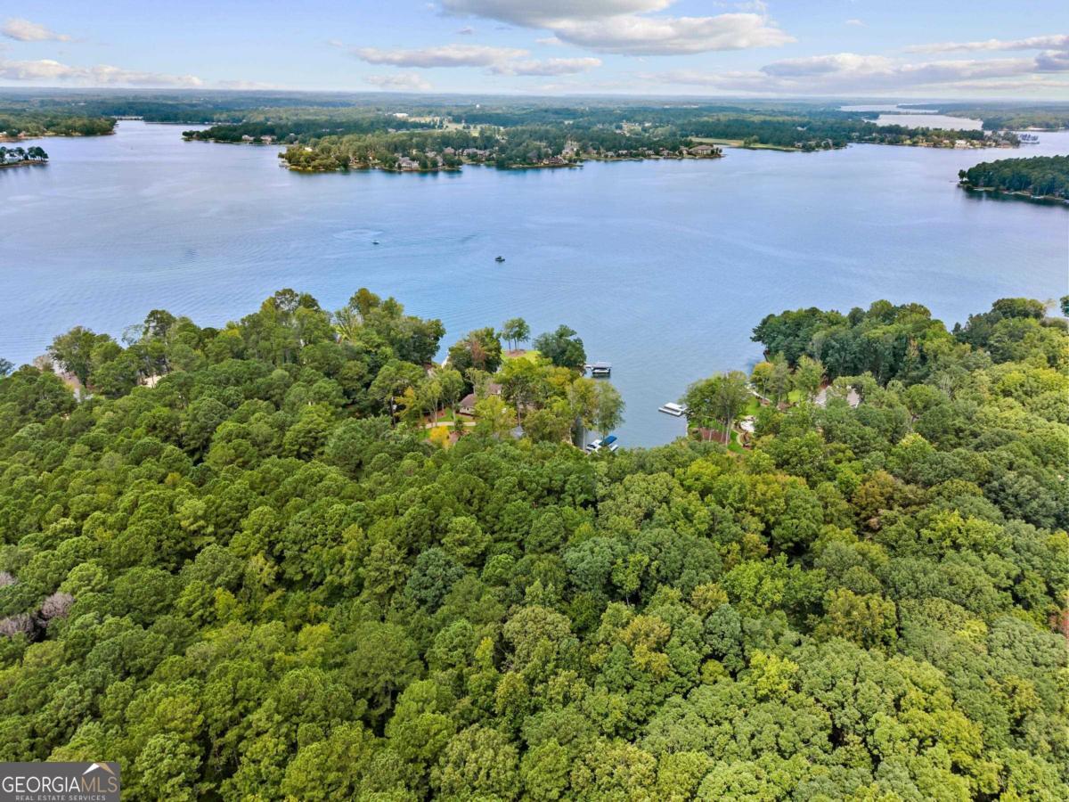 Located in the heart of the prestigious Great Waters community at Reynolds Lake Oconee, this nearly one acre lakefront lot is the perfect site for your dream home with $50,000 credit available to buyer for dock and boat lift. GA Power has approved a wharf dock and boat lift. This homesite allows direct access to the lake for fishing and water activities. Just steps from premier amenities, including the Jack Nicklaus designed golf course, clubhouse, pool, tennis courts, dining, gym, and playground, this homesite has unmatched convenience. Membership available.