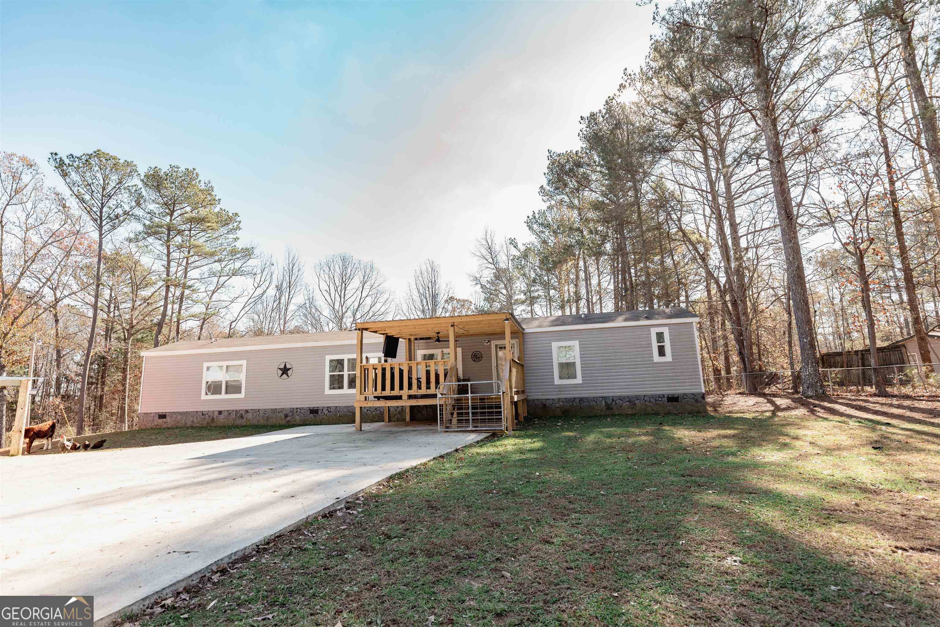 This beautiful nearly new mobile home is situated on a fenced in 1.08 acre lot. The home features a modern open floor plan with plenty of natural light, and has 3 bedrooms and 2 full bathrooms. Eat in kitchen features island bar area and stainless appliances. Outside, you'll find a large porch perfect for enjoying a cup of coffee and a spacious yard that's perfect for outdoor activities. The property also includes a 32x32 shop wired for 220 volts, and also an electronic entry gate. Don't miss your chance to own this stunning property - schedule a showing today!