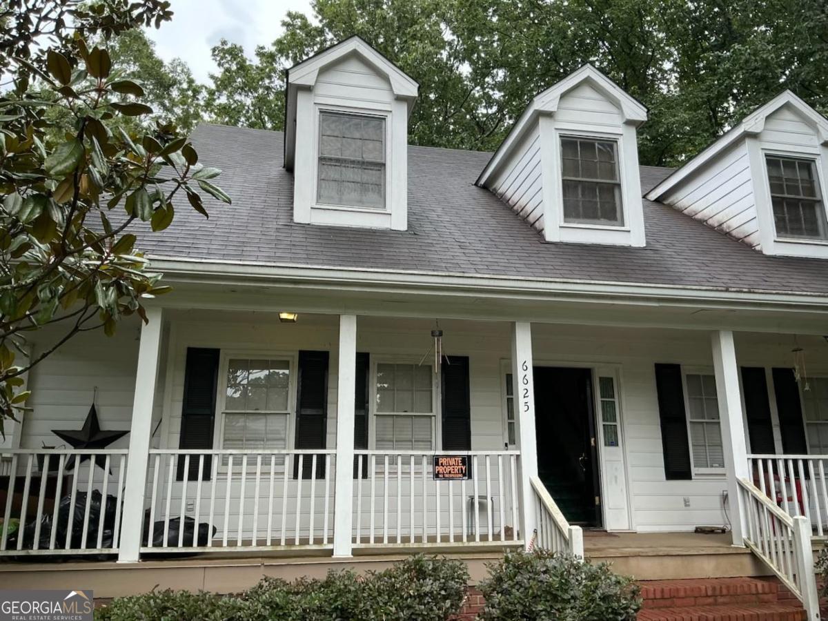 Welcome home to this charming white country-style residence tucked away on a peaceful cul-de-sac in Lithonia. Situated on over an acre of land, this inviting property blends timeless Southern charm with modern comforts. Step inside to discover 4 oversized bedrooms, each featuring its own walk-in closet, and 3.5 bathrooms, offering plenty of space for family and guests. The thoughtfully designed two-story layout is complemented by a partially finished basement, perfect for a home theater, gym, or additional living space with a studded bathroom. Enjoy gatherings on the large wrap-around porch, the perfect spot for rocking chairs and morning coffee, or retreat to the courtyard-style backyard, ideal for entertaining, gardening, or simply relaxing in your private outdoor oasis. Additional highlights include a 2-car garage, ample storage, and a serene location that still offers easy access to shopping, dining, and major highways. This is more than just a home-it's a lifestyle. This home Simply needs love to bring its natural character and charm back to life.