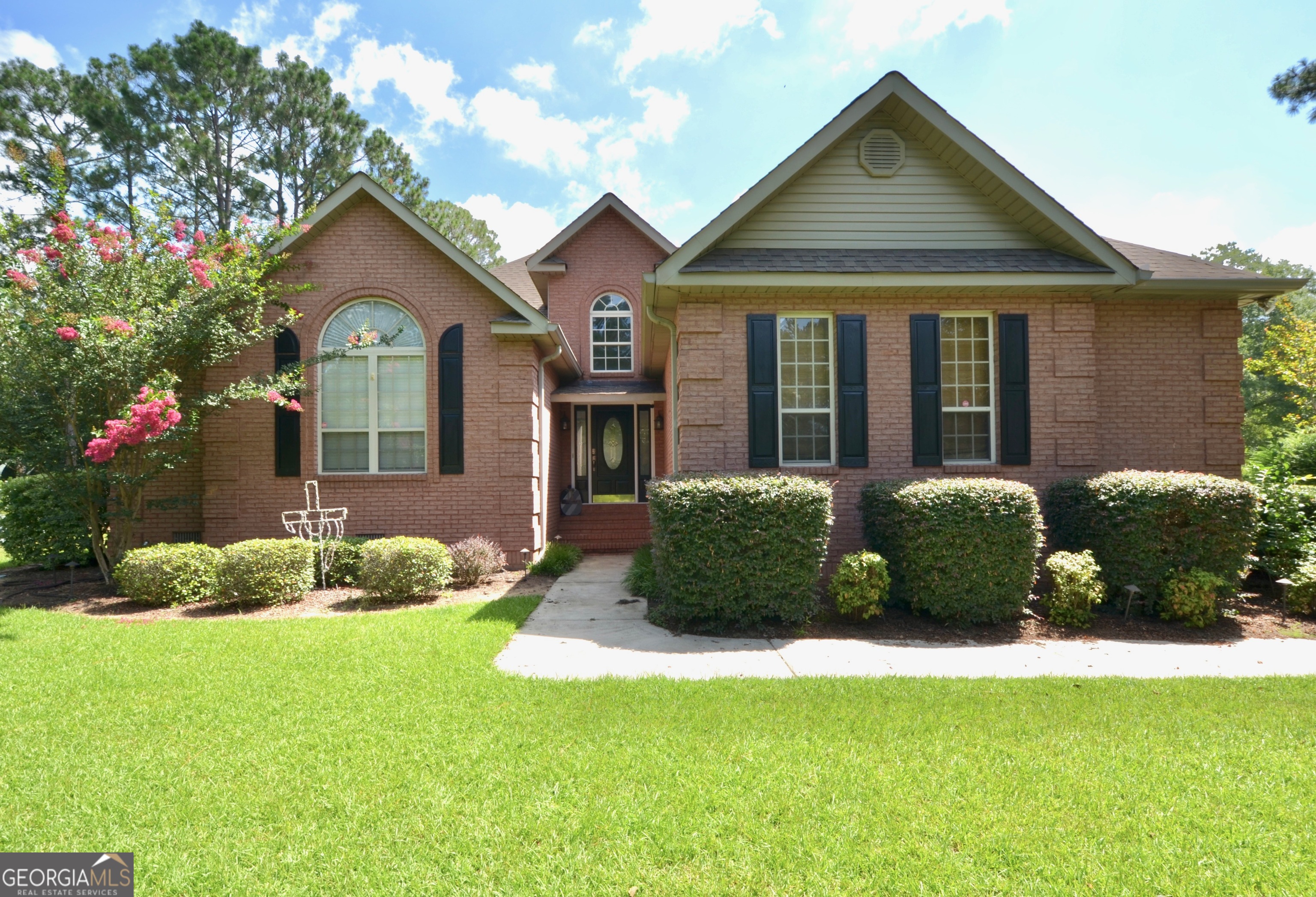 Welcome to your dream home in a well-established subdivision where quality meets comfort in perfect harmony. This stunning 3-bedroom, 2.5-bathroom residence offers 1,896 square feet of thoughtfully designed living space featuring a practical split floor plan that ensures privacy and functionality. The heart of this home showcases a well-appointed kitchen that truly shines as an entertainer's dream. With abundant cabinet storage, a convenient kitchen island, and a cozy breakfast area, this space seamlessly flows into the formal dining room adorned with elegant judges paneling. The arched entrance welcomes you into the spacious living room, where handsome hardwood floors create warmth throughout and a gas fireplace serves as the perfect gathering spot. The primary bedroom retreat offers a luxurious escape with its soaking tub, separate shower, generous walk-in closet, and double vanity. Two additional bedrooms share a convenient jack-and-jill bathroom, making this layout ideal for families or guests. Step outside to discover the large back deck, perfect for outdoor entertaining and relaxation. The outdoor wired storage building provides excellent utility space, while the double attached garage offers convenient parking and additional storage. This quality-built, 3-sided brick home sits on a generous double lot in a location that offers convenient access to Cochran, Hawkinsville, and Warner Robins. The nearby Dodge County Elementary and High Schools add to the neighborhood's appeal for families. With its combination of elegant features, practical layout, and prime location, this property represents an exceptional opportunity to own a truly special home. Call/text Becky at 478-231-5596 for your showing appointment.