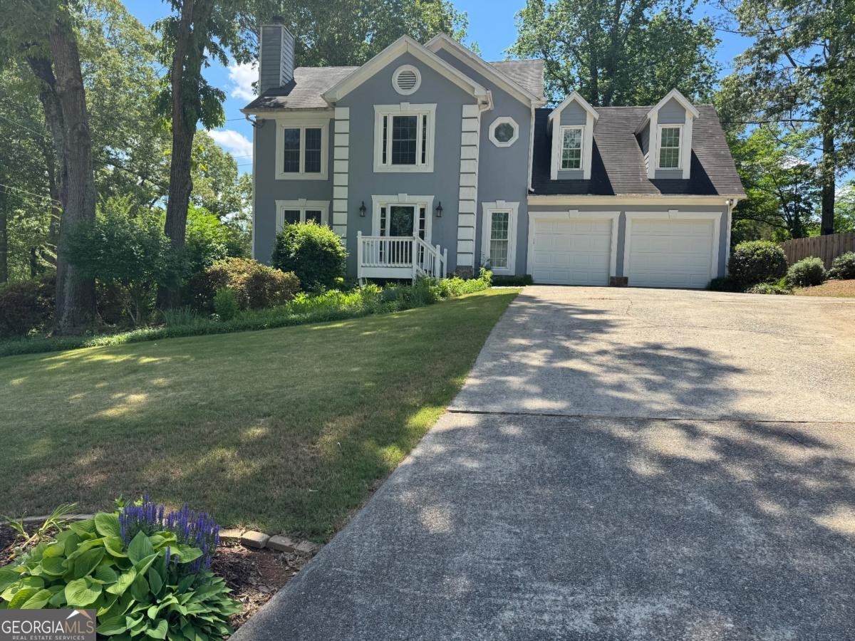 Picturesque, peaceful, and bright Move-in Ready Home! Nestled on a quiet, winding street. This 4 Bedroom, 2 1/2 Bath home includes a beautifully landscaped flat yard with over 25k spent on custom landscaping including new paver patio, custom retaining walls and new wood fencing...great for tons of outdoor entertaining and fun. Entering the foyer, you are drawn in by the airy feeling of the floorplan that flows from one room to the next. The kitchen has a breakfast nook, white cabinets, solid surface counters, stainless appliance. Kitchen leads to a fantastic screened porch perfect for al fresco dining! The family room has a fireplace and hardwood floors. Upstairs, you are ushered into the Master suite with California style closet system, and totally renovated master bath with dual vanities, penny tile flooring, frameless glass shower and frameless glass shower! Ample-sized secondary bedrooms including a large bonus room with closet that could be used for multiple purposes - bonus, playroom, office, fitness, 2nd family room, craft room - your choice! Hallway Full bath has been totally renovated with custom floor tile, subway tile in shower, custom sink and vanity. New luxury vinyl upstairs! Desirable 3rd Car Garage/Boat Door with its own private driveway! Close to schools, downtown Woodstock and Marietta Square!