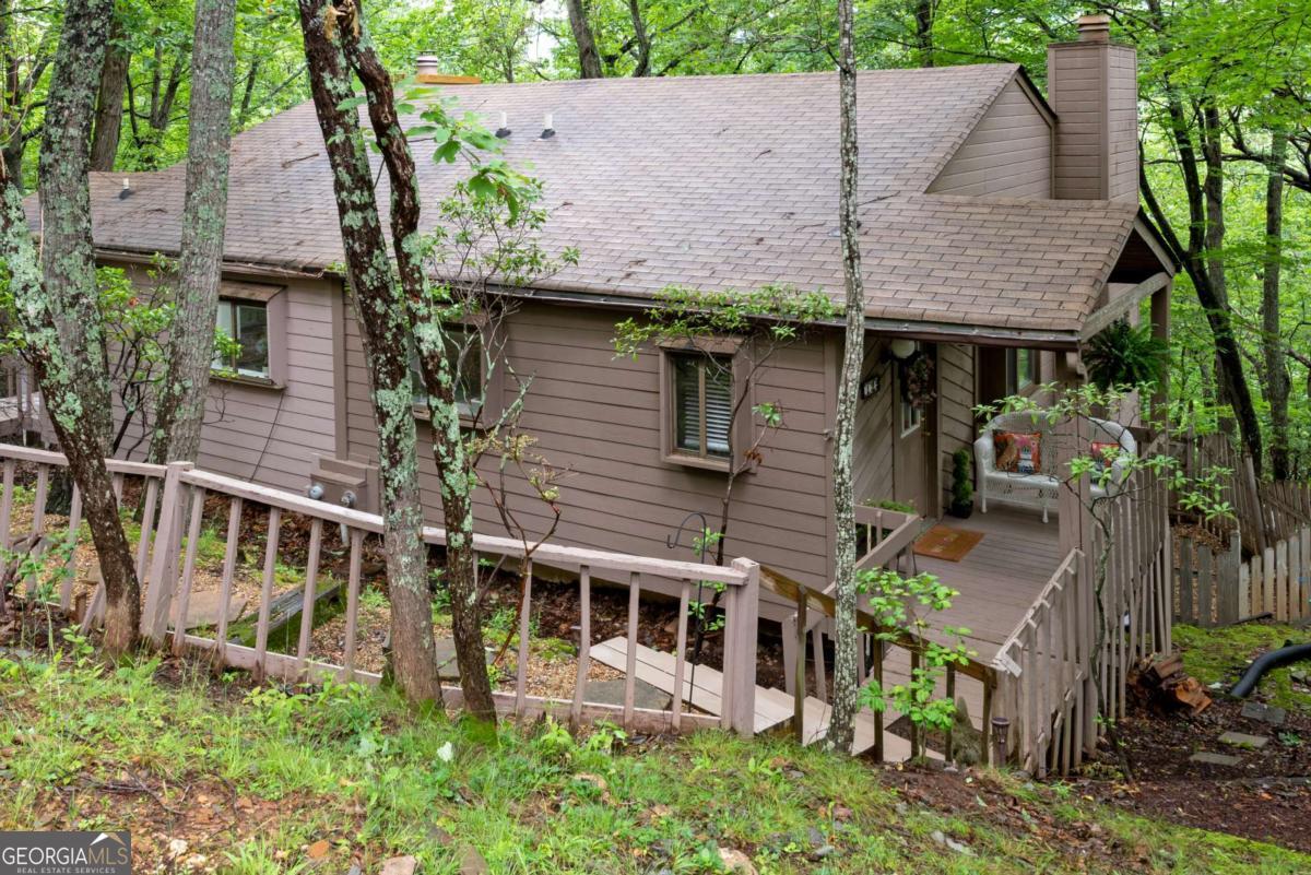 Wonderful place to Escape to your own mountain paradise in the beautiful North Georgia mountains! Don't miss this great opportunity to enjoy life in the wonderful gated community of Bent Tree, offering a perfect blend of outdoor adventure and relaxation! The possibilities are endless with this lovely 2 bedroom, 2 1/2 bath villa, which could be a primary residence, vacation home, Airbnb or rental property! This home is located just a few steps away from the clubhouse, pools, tennis, and pickleball courts!. The open floor plan has a cozy kitchen with Spacious great room has a cathedral beamed ceiling, and welcoming stone fireplace. The adjacent upper sun deck offers privacy while enjoying nature! New paint and easy to maintain laminate flooring on Main level. The deck overlooks a lovely wooded area, perfect for bird watching and observing local wildlife. The lower level features two generous master suites, each with private bath! The bedroom on the back side of the home also has a private deck! Beyond the confines of this inviting home lies the gated resort community of Bent Tree, encompassing 3500 acres of pristine landscapes. Whether you're looking for an active lifestyle, a vacation home, or a short-term rental, this retreat has something for everyone. Amenities Galore, Bent Tree boasts an impressive array of amenities, including: * Clubhouse * 18-Hole Championship Golf Course winding through the mountains * 110 acre Private Lake Tamarack for fishing and kayaking * Two Swimming Pools for both family fun and peaceful relaxation * Tennis & Pickleball Courts with indoor and outdoor options * Beach, Playground, Dog Park, Hiking Trails, and a Restaurant catered to active lifestyles and community involvement. The community also boasts a fire department ensuring every need is met within its secure perimeters. Don't miss out on the chance to make this hidden mountain gem your very own!