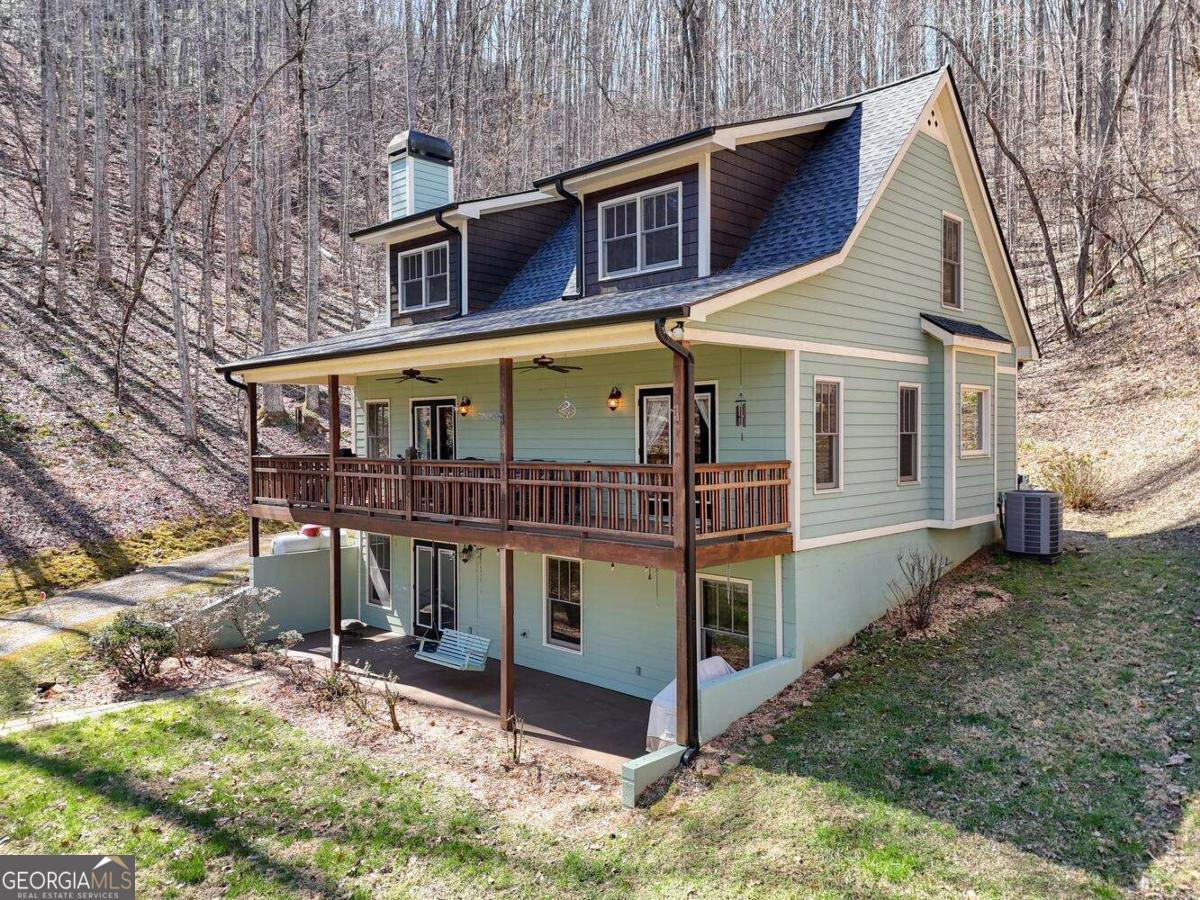 Turnkey Home & Bonus Cabin Near Lake Chatuge in Hayesville, NC. Located less than a mile from Lake Chatuge's fishing and boating access, and tucked behind Margarita Jack's Restaurant & Marina, this fully furnished, move-in-ready home offers end-of-the-road privacy surrounded by raw, wooded land. Enjoy peaceful views of the wooded valley and regular visits from deer, hawks, and squirrels right outside your door. This charming home features: New roof with transferable warranty, Durable Hardie board siding, French doors opening to a covered upper deck, New HVAC system installed in 2023, Spacious walk-in closets, Cozy stacked stone fireplace with gas logs, Approximate elevation of 1,100 feet, full basement offering expansion potential and already stubbed for a full bath, and much more. Included with the property is a separate cabin, recently renovated with a new metal roof, updated flooring, and cedar interior walls. The cabin is in excellent structural condition. Only needs some basic plumbing work and fixtures (stove, sink, toilet) to be fully functional. A recent survey is available. This unique property is a must-see-whether you're looking for a full-time residence or mountain getaway.