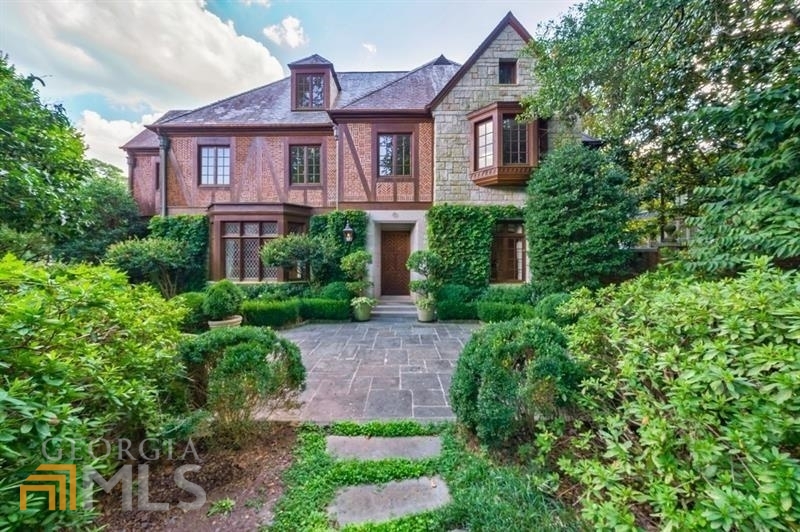 Beautiful English Tudor home in sought-after Haynes Manor. Thoughtfully designed by Pak Heydt, this charming home offers oversized living spaces, ideal for entertaining. Architectural details throughout include wooden beams, leaded glass windows, coffered ceilings and incredible woodwork. Floorplan includes formal living room, dining room and handsome wood paneled den. Kitchen offers granite counters, island, stainless steel appliances, opens to the breakfast room & keeping room with French doors leading to the covered porch. Upper level staircase leads to oversized master suite with walk-in closet and luxurious master bath. Upper level also hosts 3 secondary bedrooms with en-suite baths. Finished terrace level offers media room, bedroom, 2 full baths and access to the 2 car garage. Lovely manicured grounds include mature landscaping, pool, fountain and outdoor grilling area.